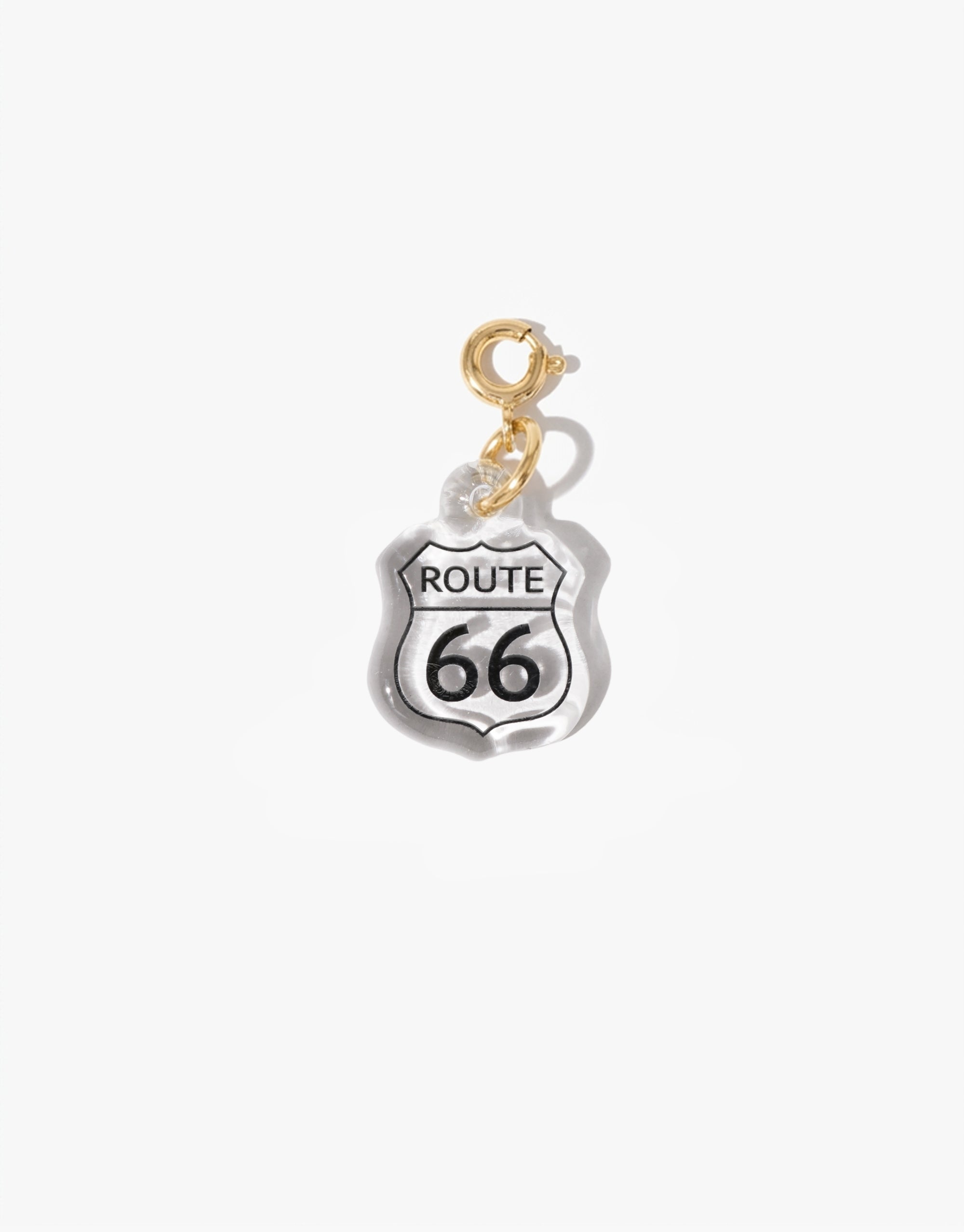 A clear Eco Gem charm shaped like a Route 66 highway sign with black and white detailing, finished with a gold vermeil spring ring clasp.