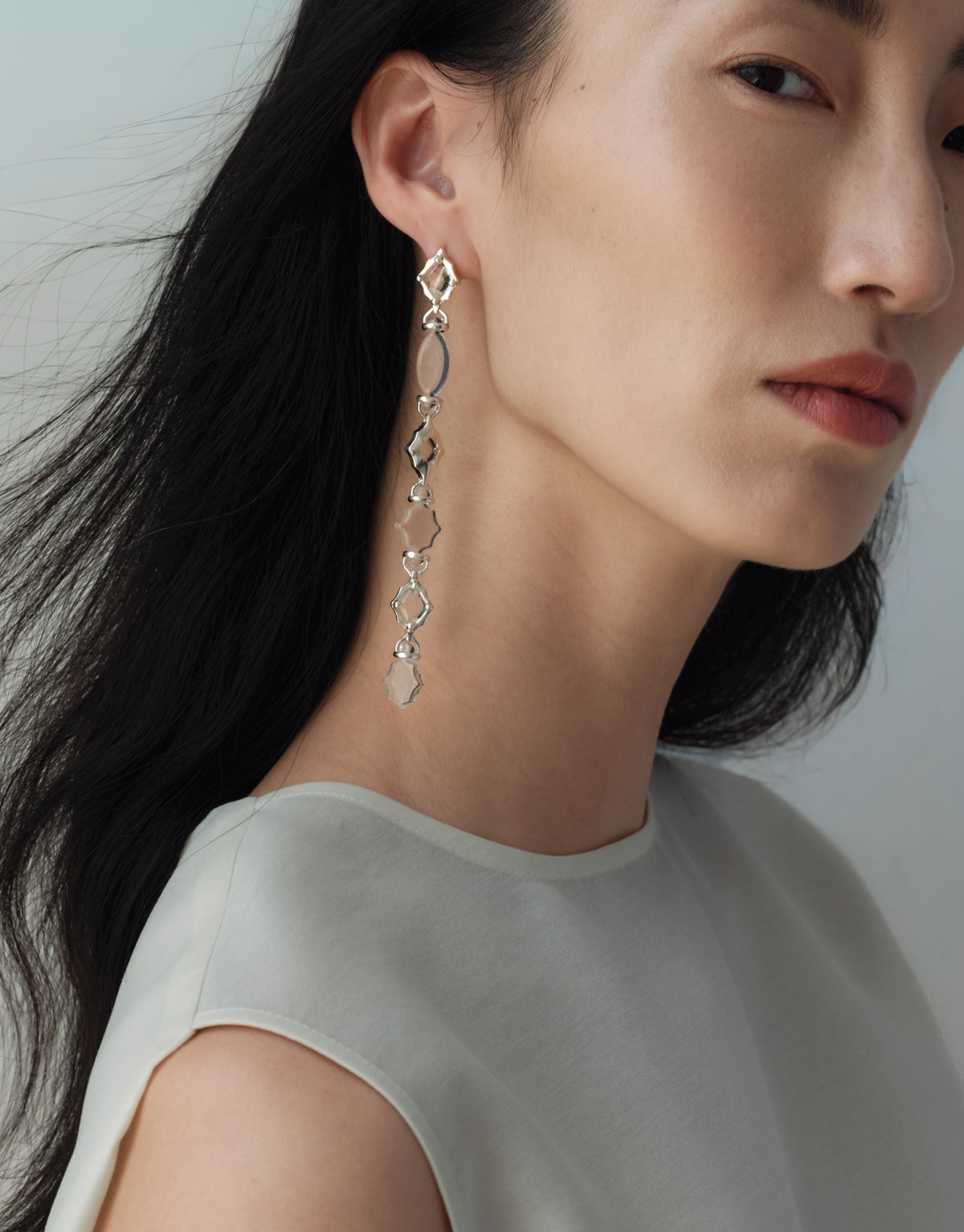 Cadence Linear Earring in black basalt glass, a long single drop of graduating upcycled glass Eco Gems in sterling silver. Cadence Linear Earring by CLED.