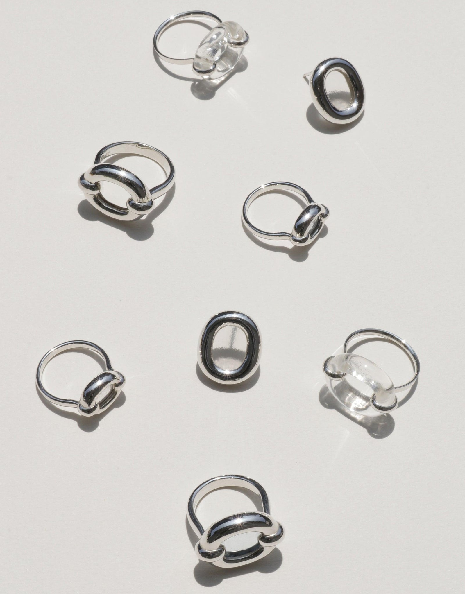 Assortment of elegant silver Core Loop Rings in various designs, showcasing the Small size option. Minimalist and stylish jewelry pieces symbolizing unity and upcycling. Sustainable fashion accessories from the Loop Collection by CLED. Core Loop Ring | Small