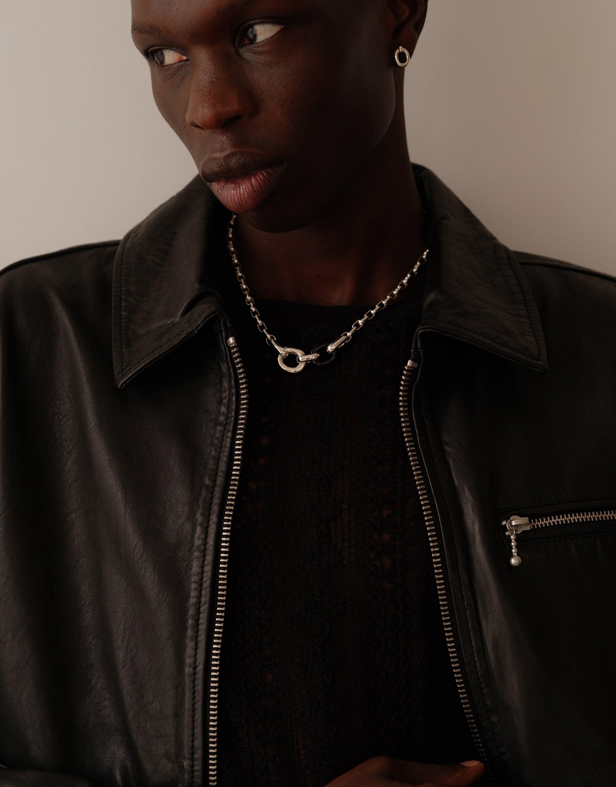 Stylish Loop Chain Necklace worn by model in black leather jacket, showcasing the elegant design and versatility of the upcycled jewelry piece. Part of the In The Loop collection, symbolizing unity and sustainability. CLED, Loop Chain Necklace.