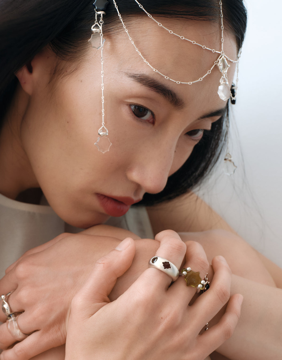 LAS Scallop Swivel Ring | Engraving worn on the model with a CLED chain draped across the face, upcycled glass Eco Gems in sterling silver. Handmade in Los Angeles. LAS Scallop Swivel Ring | Engraving by CLED.