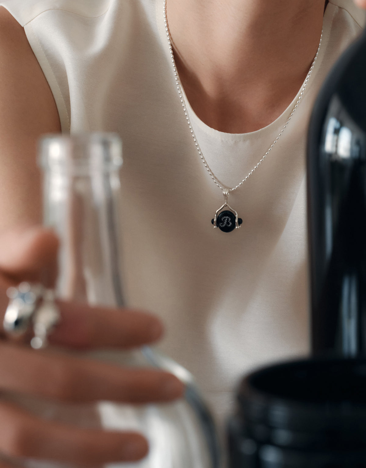 LAS Oval Swivel Pendant | Engraving worn on the model on a fine sterling silver chain, the engraved face resting at the collarbone. Handmade in Los Angeles. LAS Oval Swivel Pendant | Engraving by CLED.