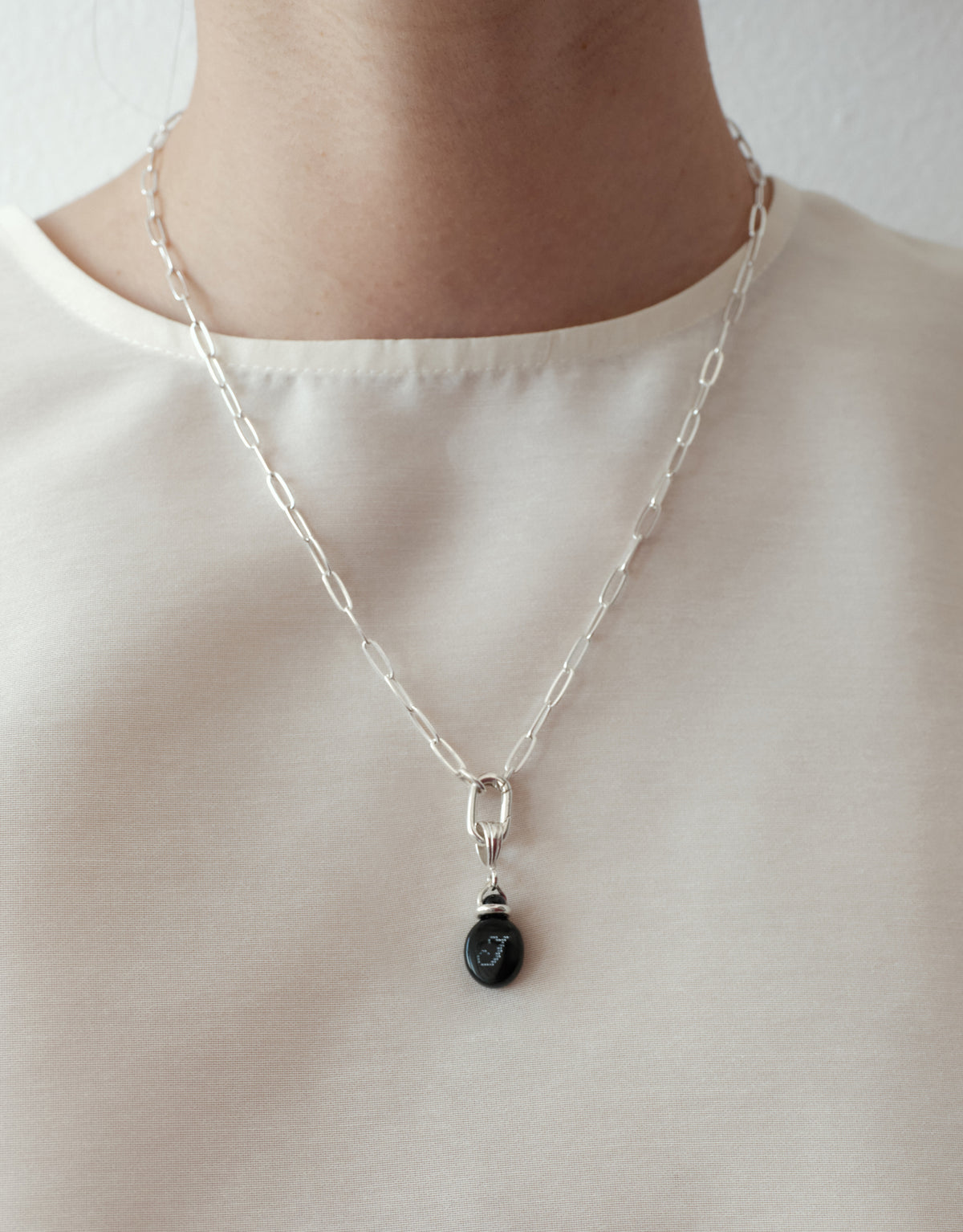 LAS Oval Pendant worn on the model, upcycled glass Eco Gem set in sterling silver. Handmade in Los Angeles. LAS Oval Pendant by CLED.