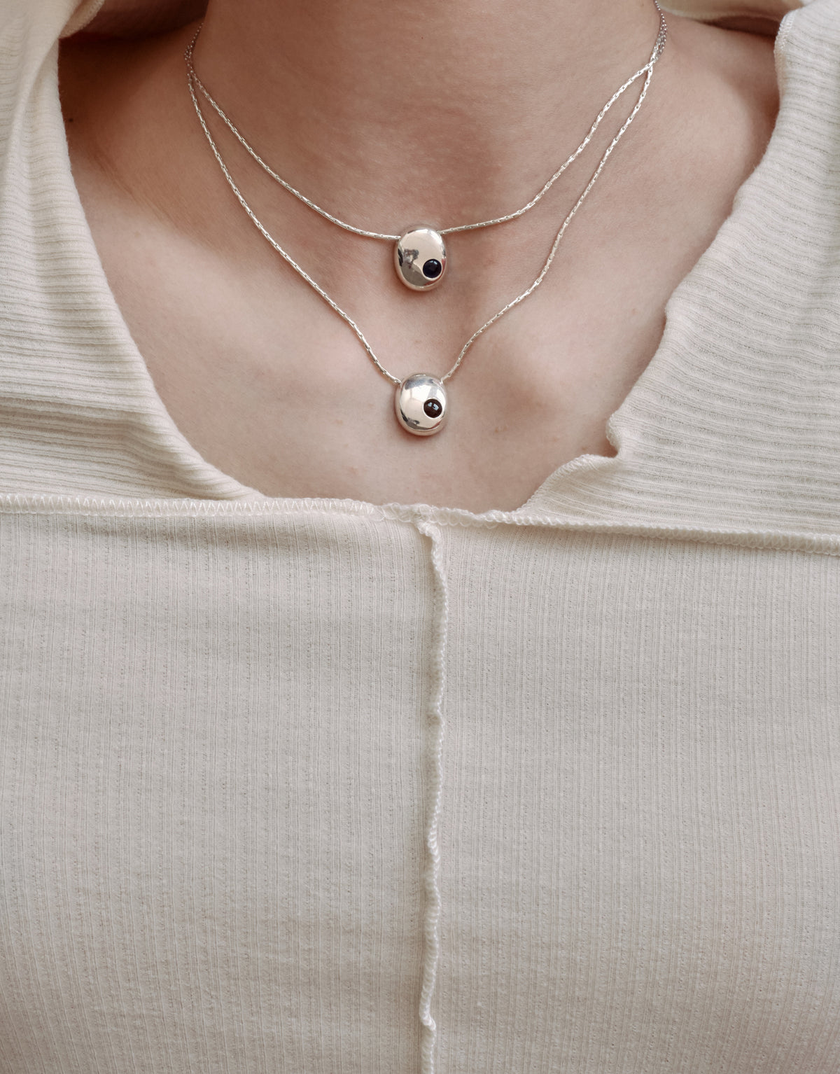 Inter Loop Necklace worn on the model, upcycled glass Eco Gem set in sterling silver. Handmade in Los Angeles. Inter Loop Necklace by CLED.