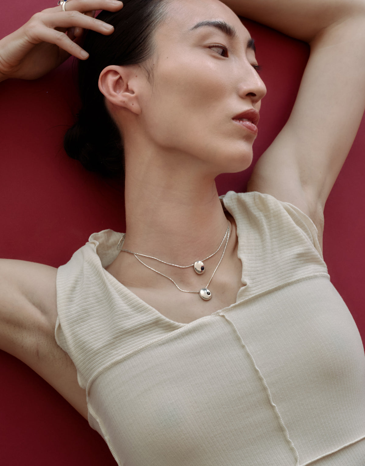 Inter Loop Necklace worn on the model, upcycled glass Eco Gem set in sterling silver. Handmade in Los Angeles. Inter Loop Necklace by CLED.