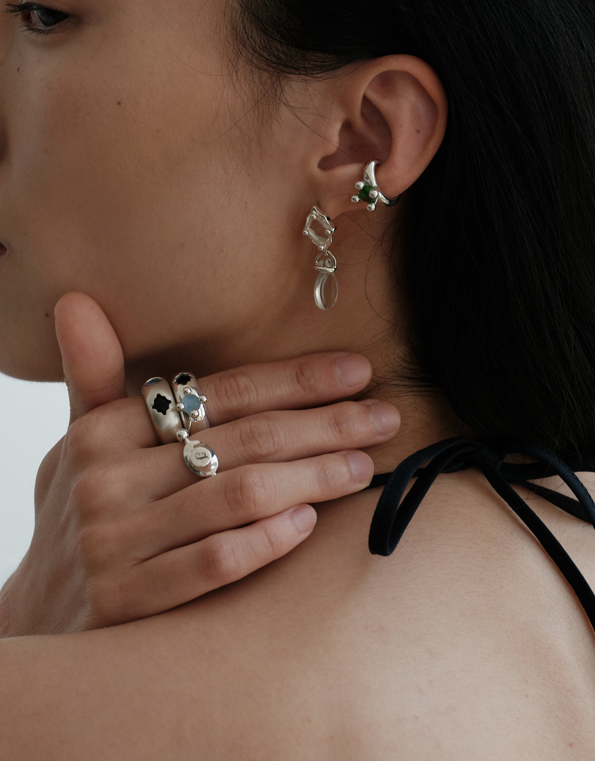 LAS Oval Swivel Ring | Metal worn on the model at the neck, styled with CLED earrings in sterling silver. Handmade in Los Angeles. LAS Oval Swivel Ring | Metal by CLED.