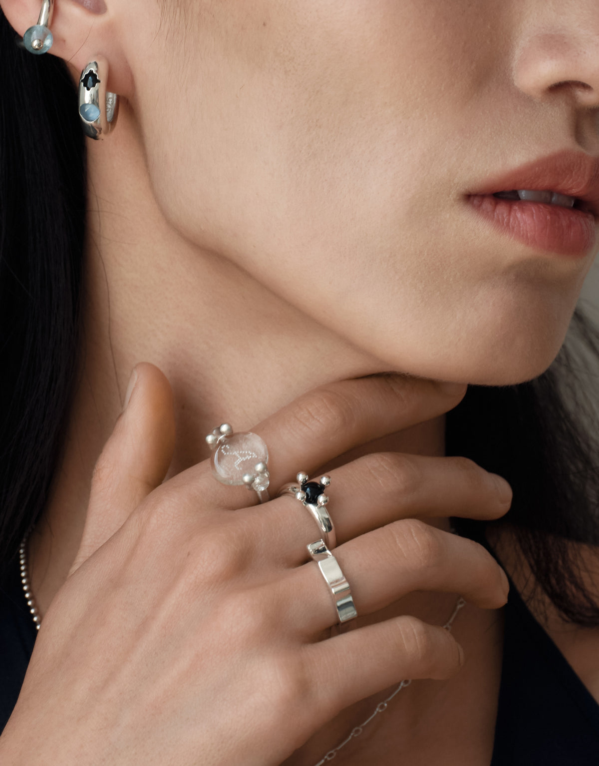 Repeat Ring worn on the model at the neck, upcycled glass Eco Gems set in sterling silver. Handmade in Los Angeles. Repeat Ring by CLED.
