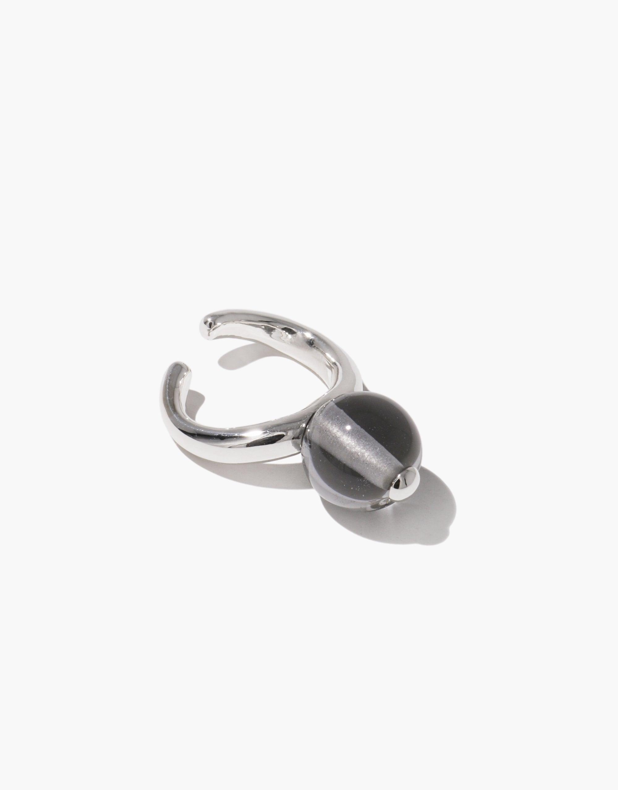 Sleek silver ear cuff with spherical gray bead, inspired by organic pea pod shapes. Adjustable design for comfortable wear. Nature-inspired jewelry piece. Pea Ear Cuff | Large. CLED