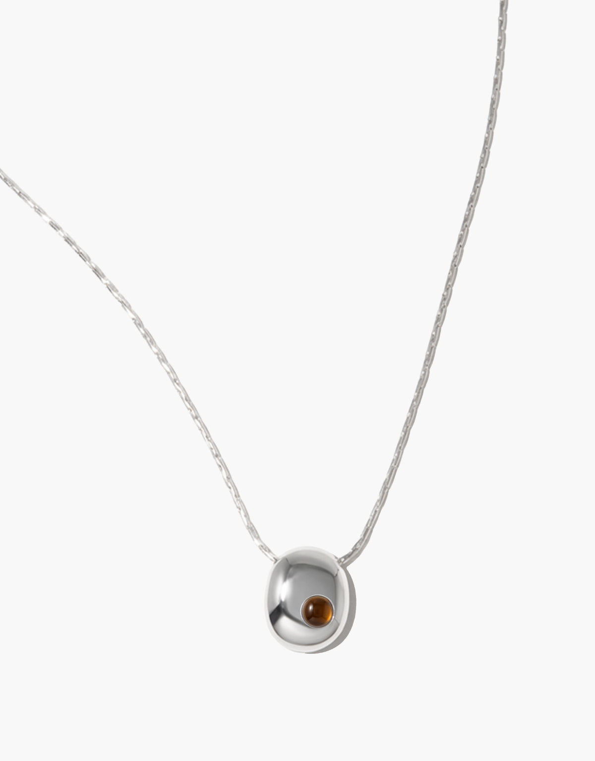 Inter Loop Necklace in brown amber glass, an upcycled Eco Gem set in sterling silver. Handmade in Los Angeles. Inter Loop Necklace by CLED.