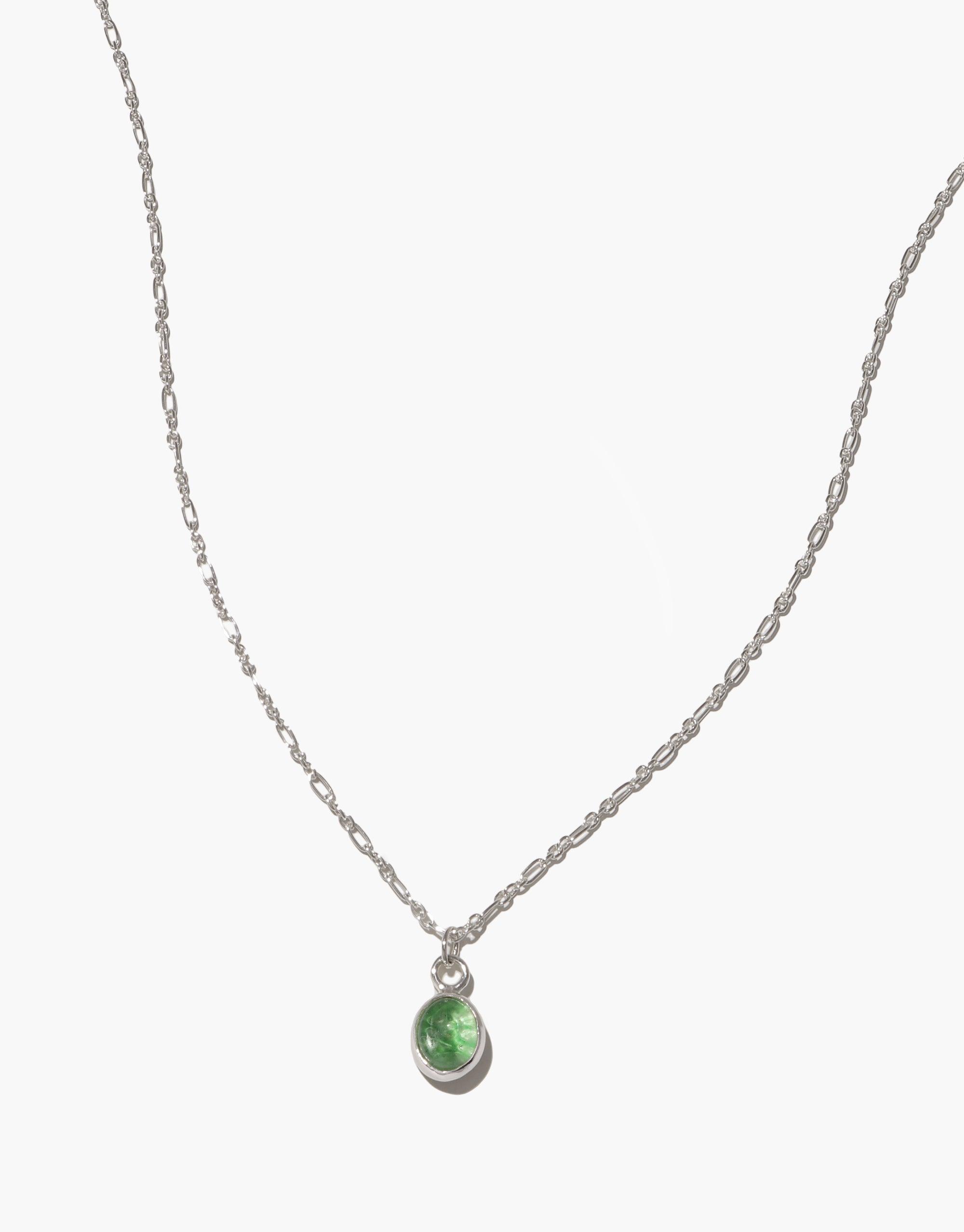 Delicate silver chain necklace with small oval green charm pendant, showcasing eco-friendly upcycled glass. Adjustable length for versatile styling. Handcrafted jewelry piece. Oval Charm Necklace by CLED.