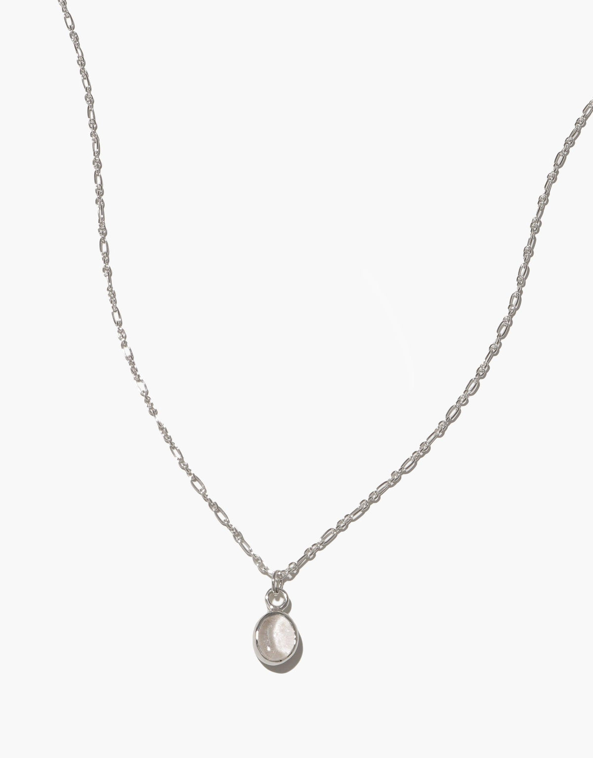 Delicate silver chain necklace with small oval-shaped pendant, showcasing minimalist design and eco-friendly craftsmanship. Oval Charm Necklace featuring adjustable length and handmade quality, perfect for everyday wear. CLED
