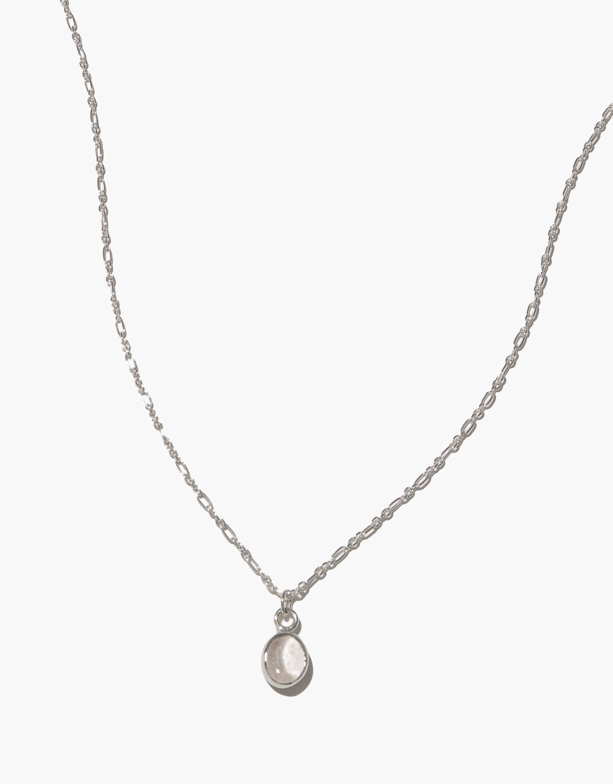 Delicate silver chain necklace with small oval-shaped pendant, showcasing minimalist design and eco-friendly craftsmanship. Oval Charm Necklace featuring adjustable length and handmade quality, perfect for everyday wear. CLED
