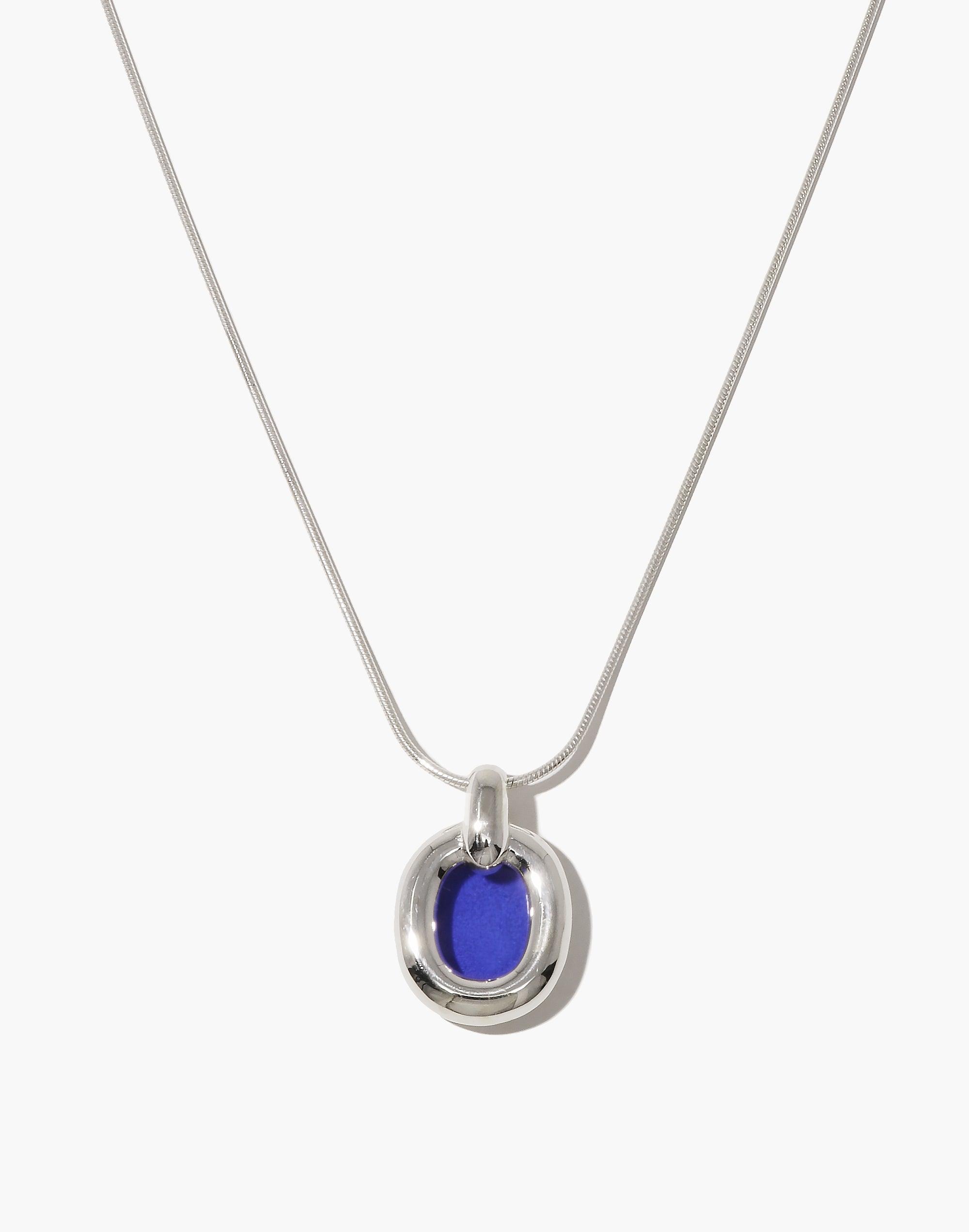 Elegant Core Loop Necklace featuring a sleek snake chain and circular pendant with vibrant blue upcycled glass accent. Modern, sustainable design symbolizing unity and interconnectedness. Perfect for everyday wear or special occasions. Core Loop Necklace | Snake Chain by CLED.