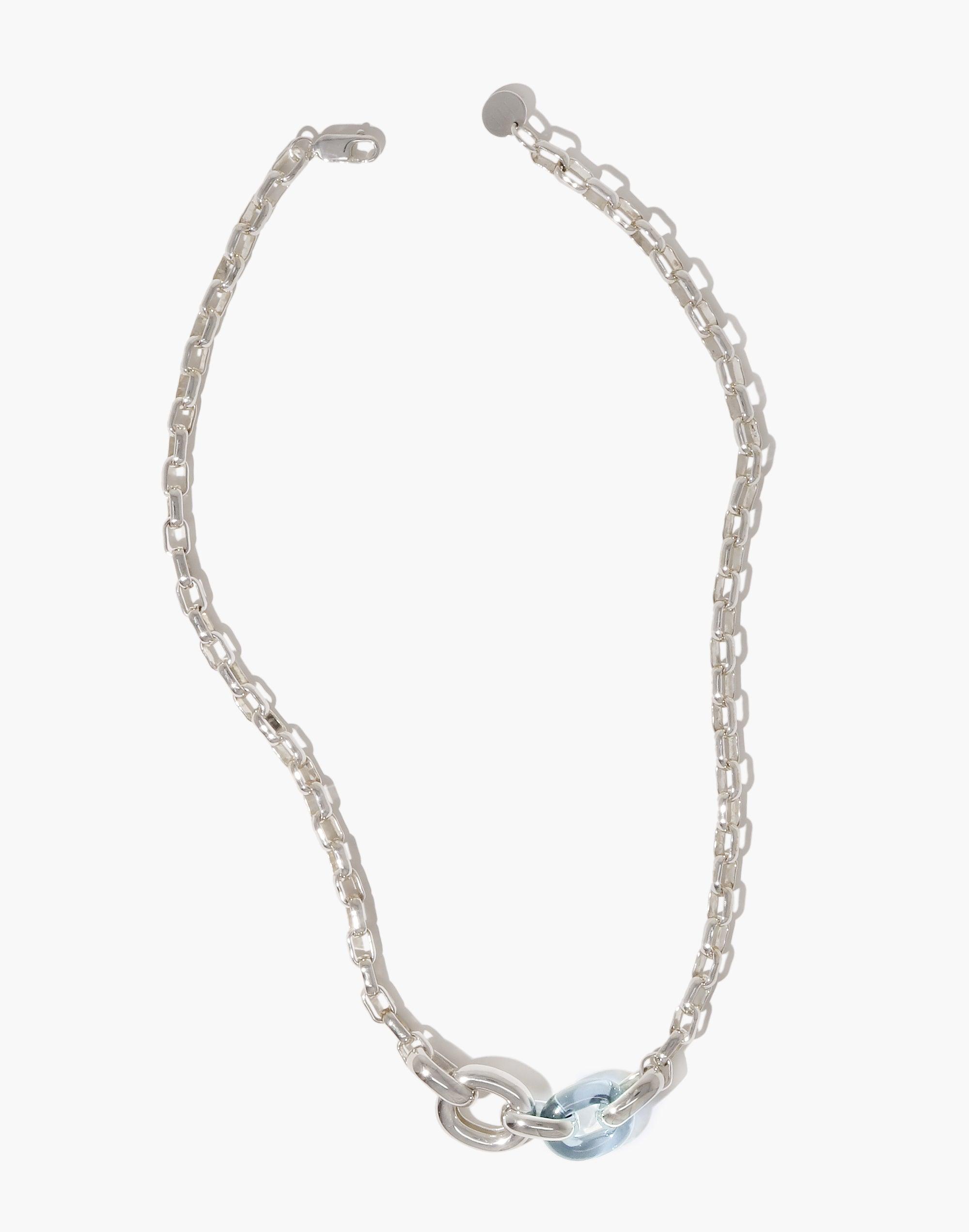 Elegant Loop Chain Necklace featuring interlocking silver-toned links and a light blue glass accent, symbolizing unity and upcycling. A stylish, sustainable accessory from the In The Loop collection by CLED.