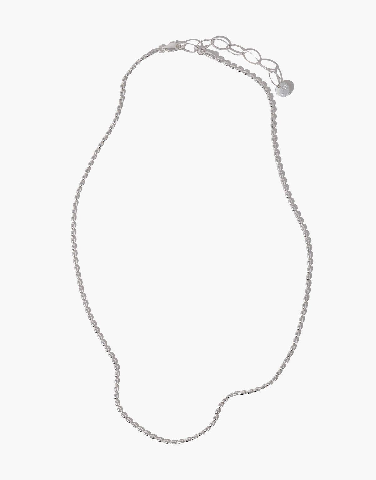 A delicate silver oval beaded chain necklace with an adjustable lobster clasp and a small round tag, displayed on a light gray background.