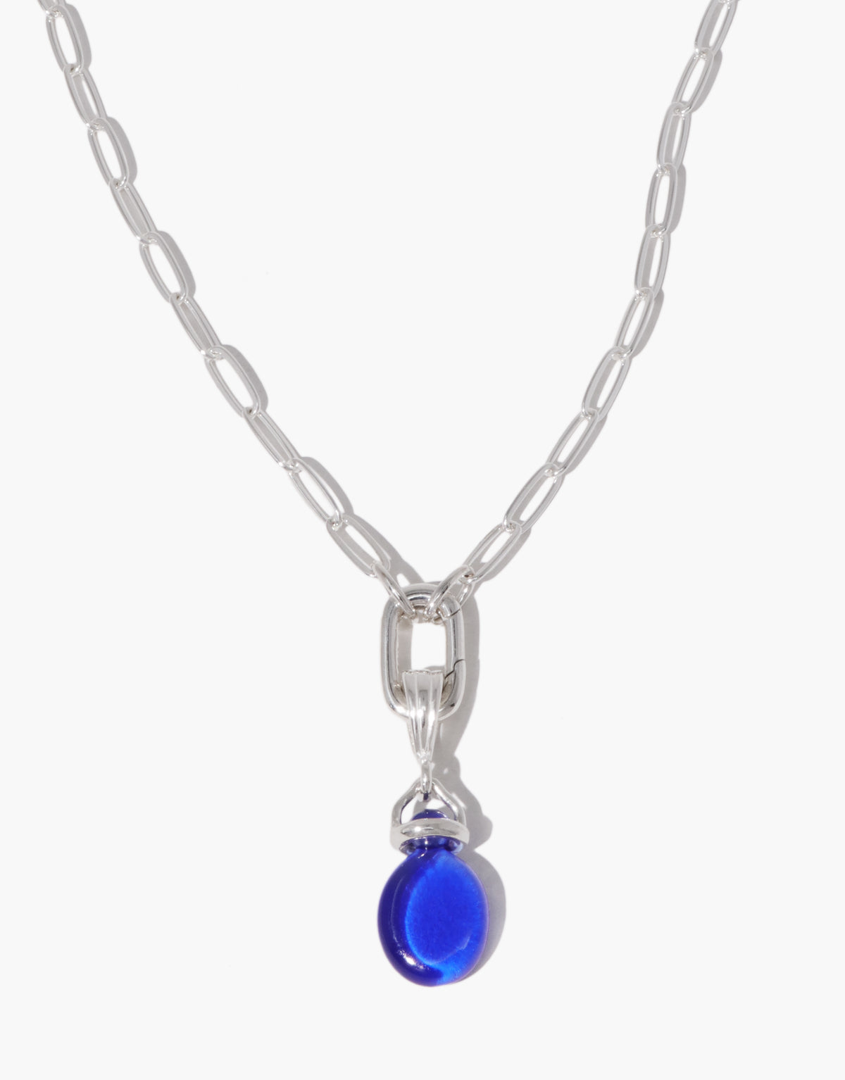 Las Pendant | Oval in blue ocean glass worn on a fine silver chain, the engraved oval resting at the collarbone. Las Pendant | Oval by CLED.