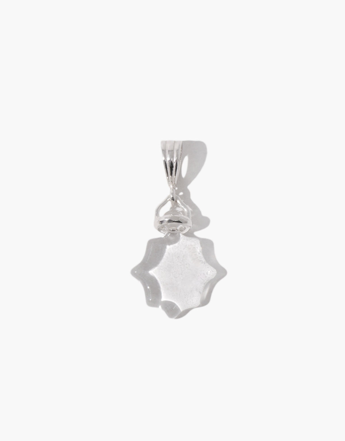 Close-up of the Las Pendant | Scallop showing the scalloped edge of the clear glass Eco Gem and the engraved face. Las Pendant | Scallop by CLED.