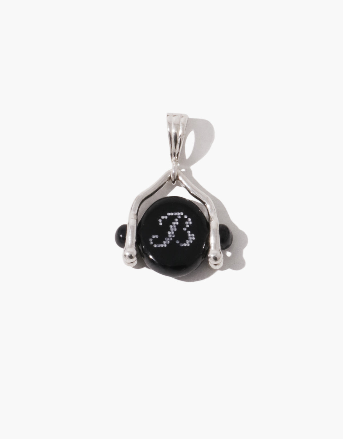 Las Swivel Pendant | Oval in sterling silver, a black basalt glass Eco Gem set between two beaded arms so it turns on its axis. Las Swivel Pendant | Oval by CLED.
