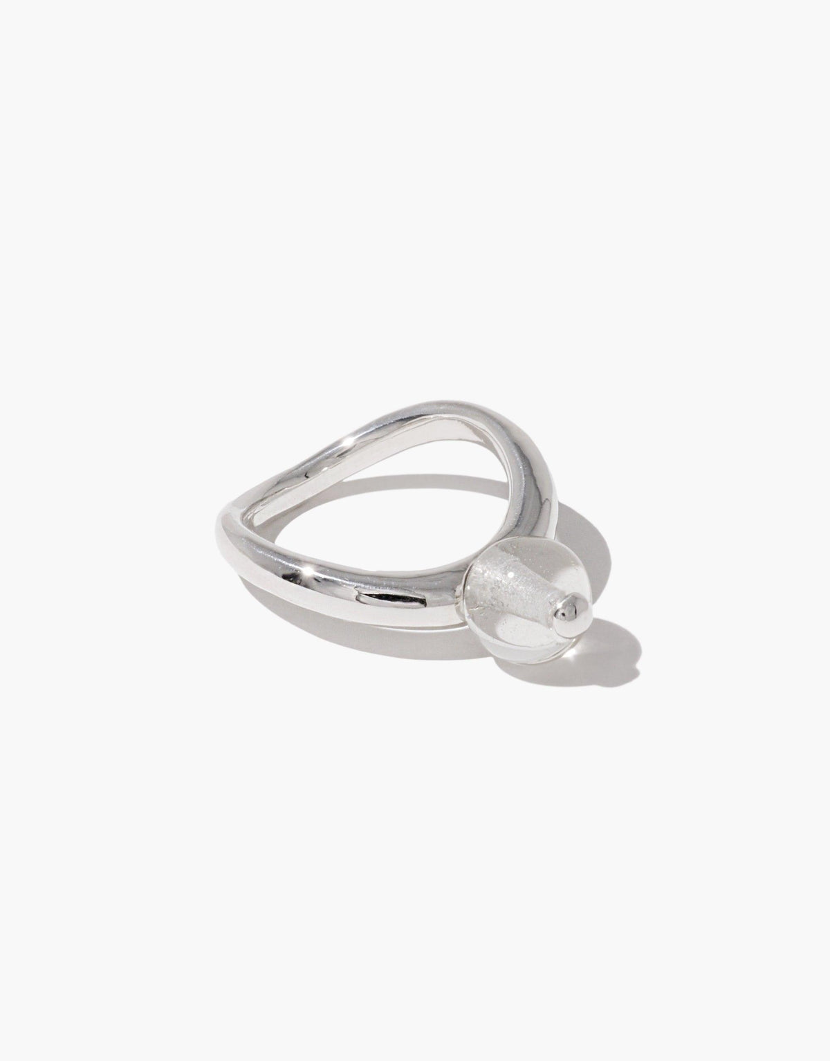 Sleek silver ring with curved design and clear spherical accent, inspired by nature's organic shapes. Pea Curve Ring | Small showcases elegant simplicity and modern style. CLED