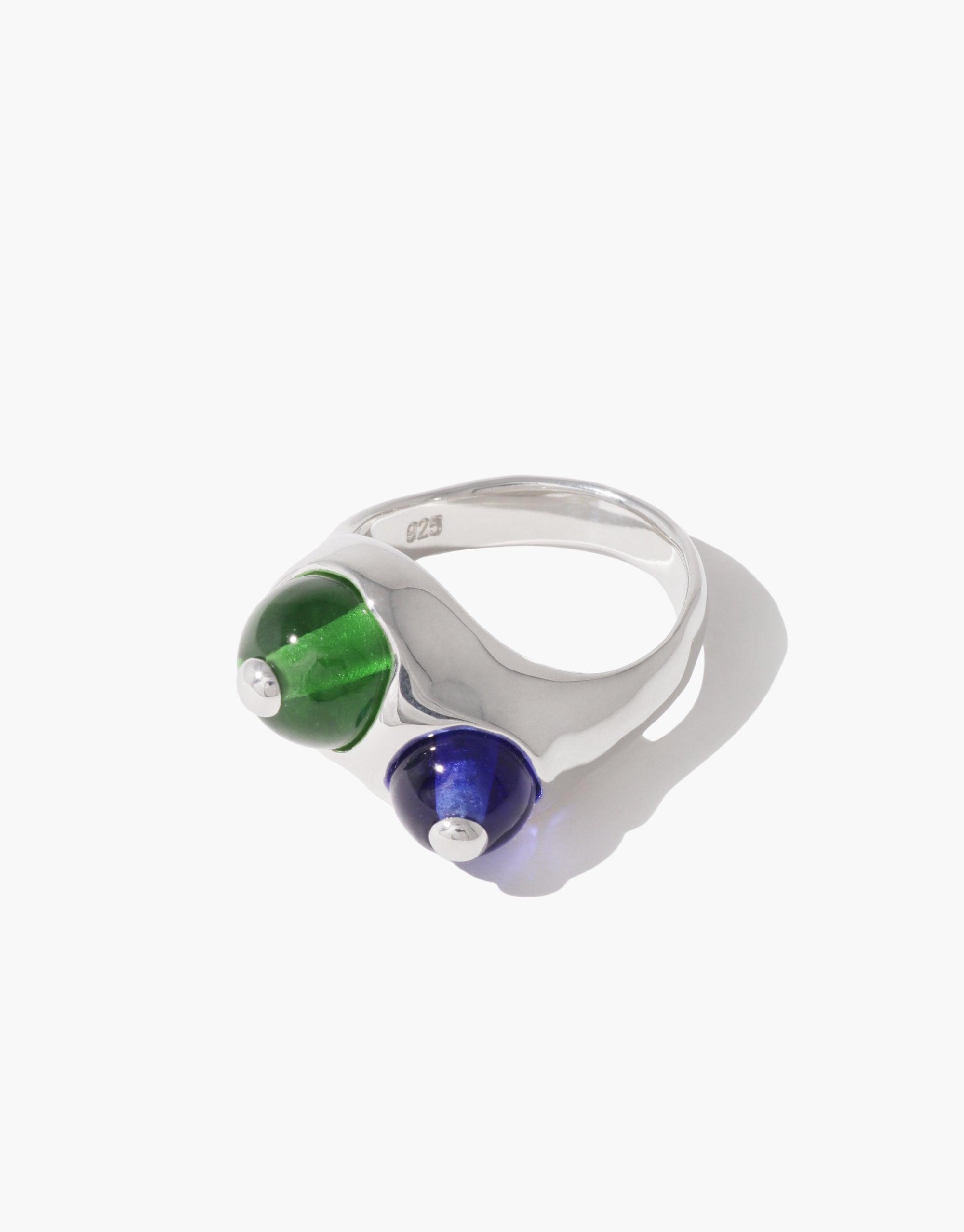 Elegant Pod Ring featuring two contrasting spherical elements in vibrant green and deep blue, set on a sleek silver band. Inspired by nature's organic forms, this unique piece captures the essence of growth and transformation. Handcrafted jewelry by CLED.
