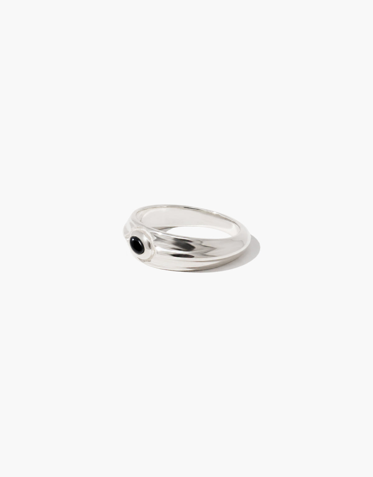 Eyelet Scallop Ring in sterling silver with a black basalt glass Eco Gem set in a scalloped eyelet at the center of a domed band. Eyelet Scallop Ring by CLED.