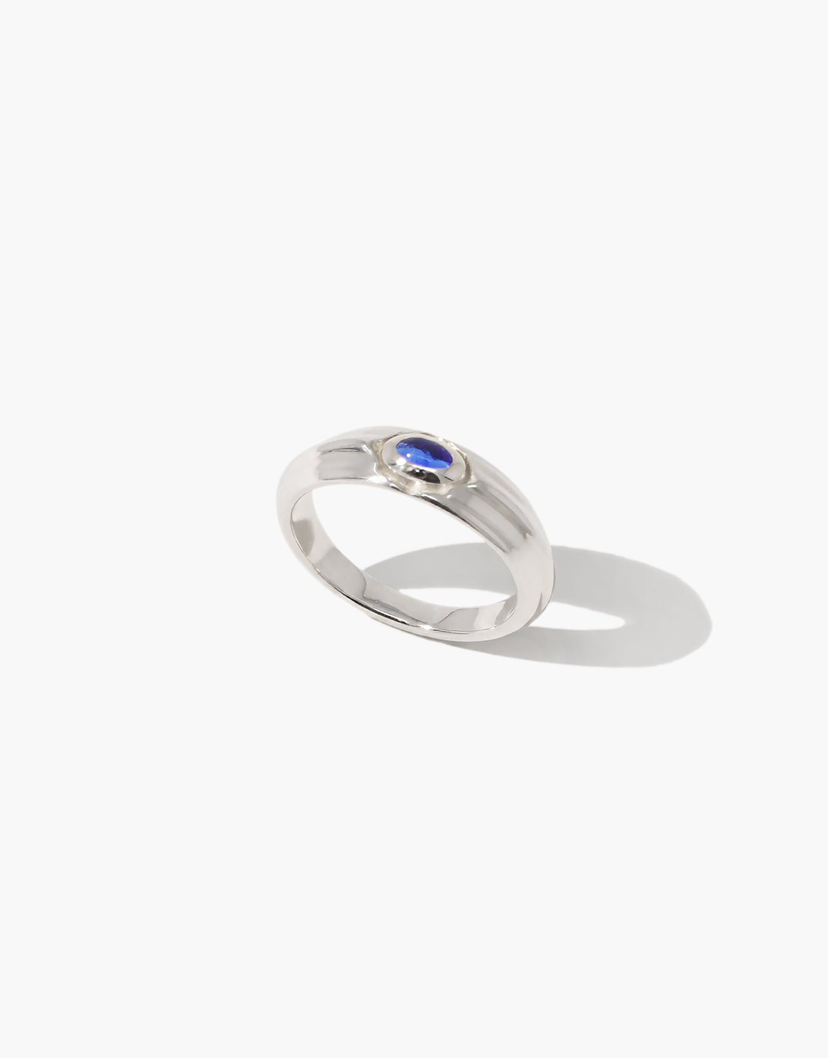Angled view of the Eyelet Scallop Ring in blue ocean glass, showing the grooved sides of the sterling silver band. Eyelet Scallop Ring by CLED.