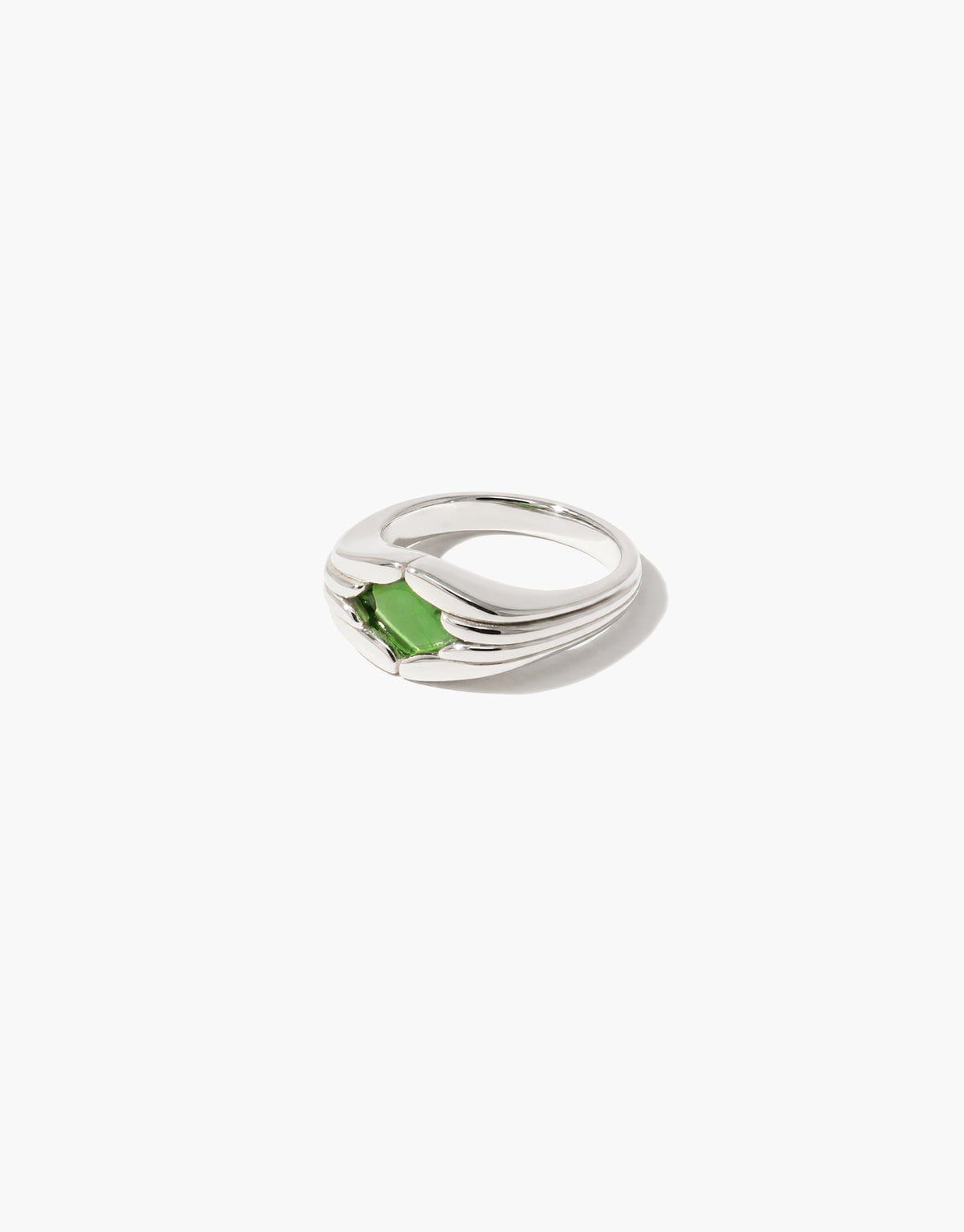 Side view of the Fluted Ring showing the grooved silver shoulders rising to the green forest glass stone at the center. Fluted Ring by CLED.