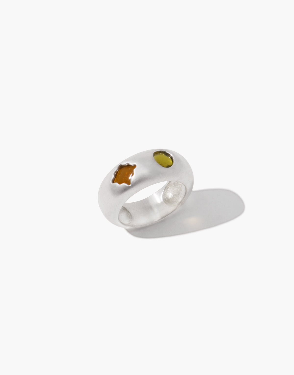 Las Duo Ring in brushed sterling silver with two glass Eco Gems set flush into the band, one light olive oval and one brown amber cut stone. Las Duo Ring by CLED.