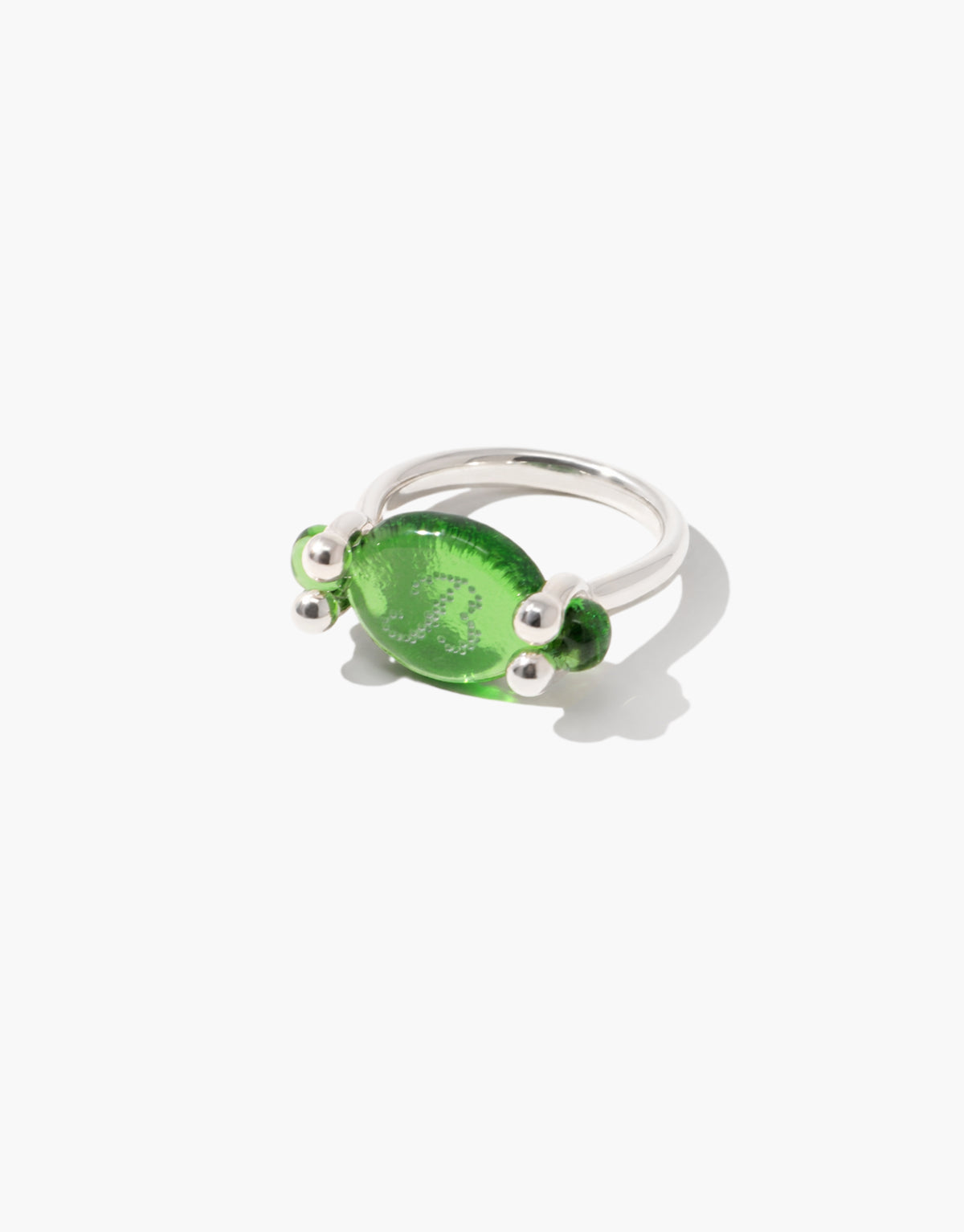Las Swivel Ring | Oval with a deep green forest glass Eco Gem turning on its own axis between beaded posts, one face engraved. Las Swivel Ring | Oval by CLED.