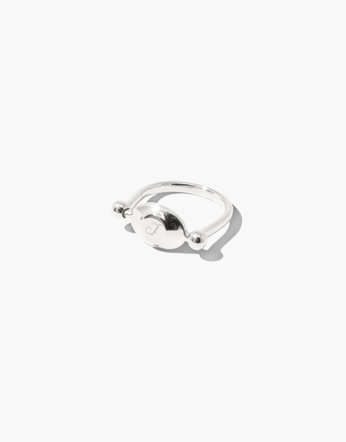 Las Swivel Ring | Oval Metal in polished sterling silver with an engraved oval face that turns between two beads. Las Swivel Ring | Oval Metal by CLED.