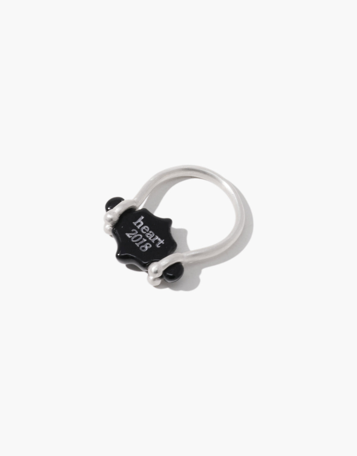 Side view of the Las Swivel Ring | Scallop showing the black basalt glass stone and the beaded pivot posts on a slim sterling silver band. Las Swivel Ring | Scallop by CLED.