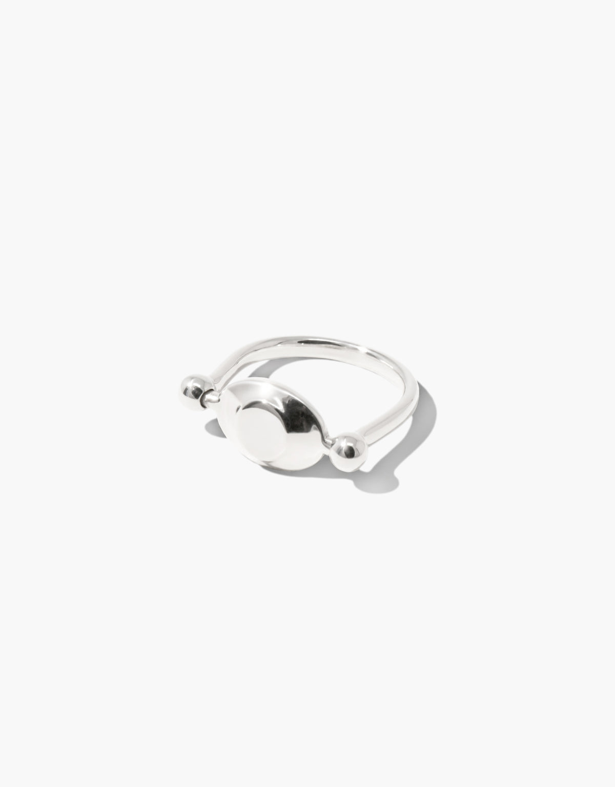 LAS Oval Swivel Ring | Metal cast in sterling silver, the smooth form turning between two beads. Handmade in Los Angeles. LAS Oval Swivel Ring | Metal by CLED.