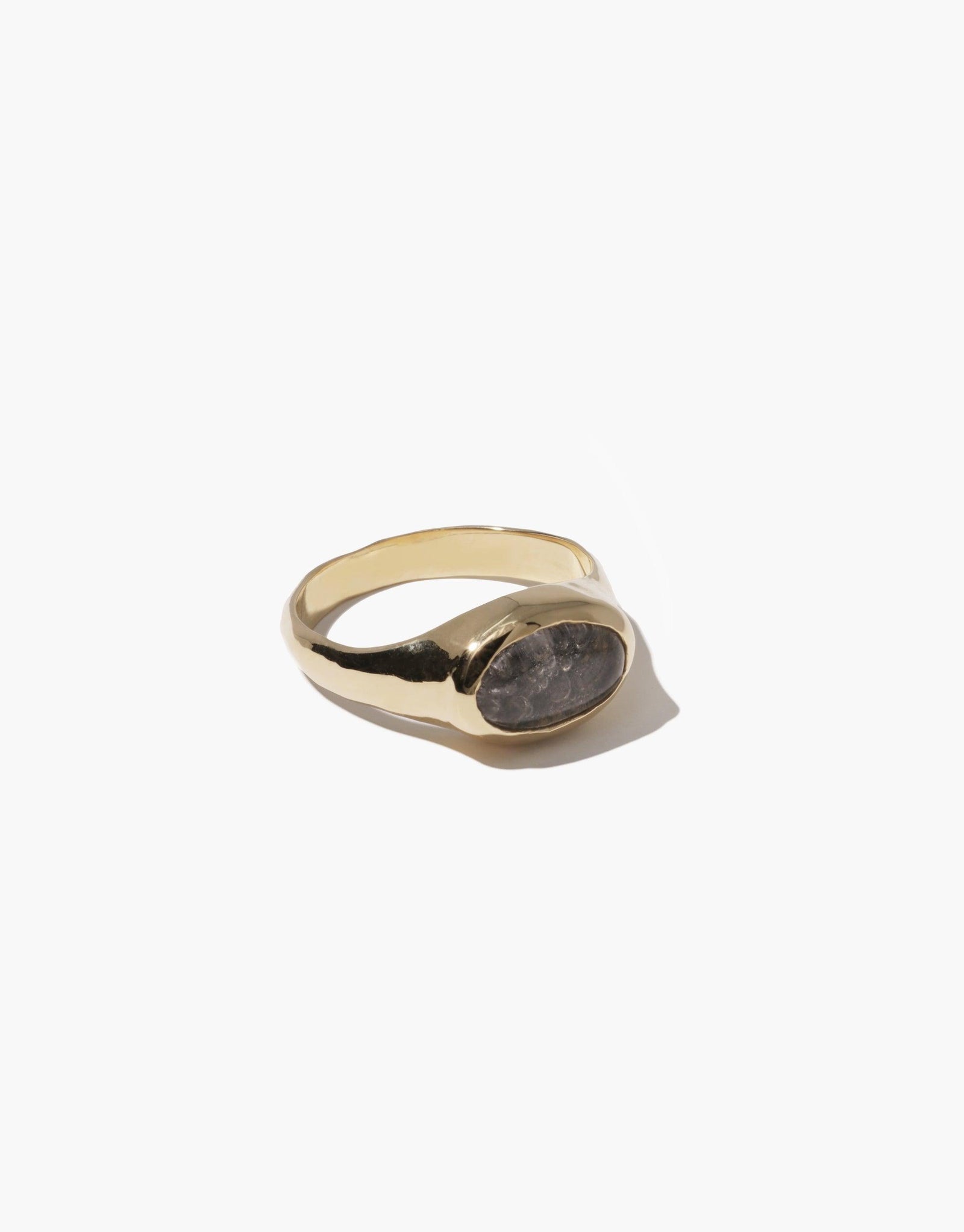Oval Sculpture Ring featuring a gold-toned band with a unique oval-shaped grey stone setting. Handcrafted design showcasing eco-friendly upcycled glass. Elegant and sustainable jewelry piece by CLED.