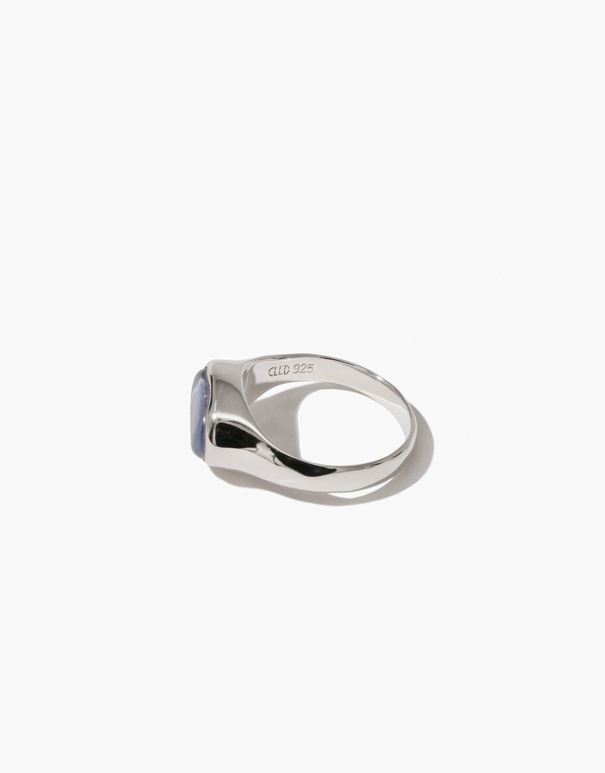 Oval Sculpture Ring featuring a sleek silver band with an asymmetrical design, showcasing a light blue oval-shaped upcycled glass charm. Handcrafted eco-friendly jewelry piece with a modern, artistic flair. Available in sterling silver or gold-plated brass. CLED, Oval Sculpture Ring.