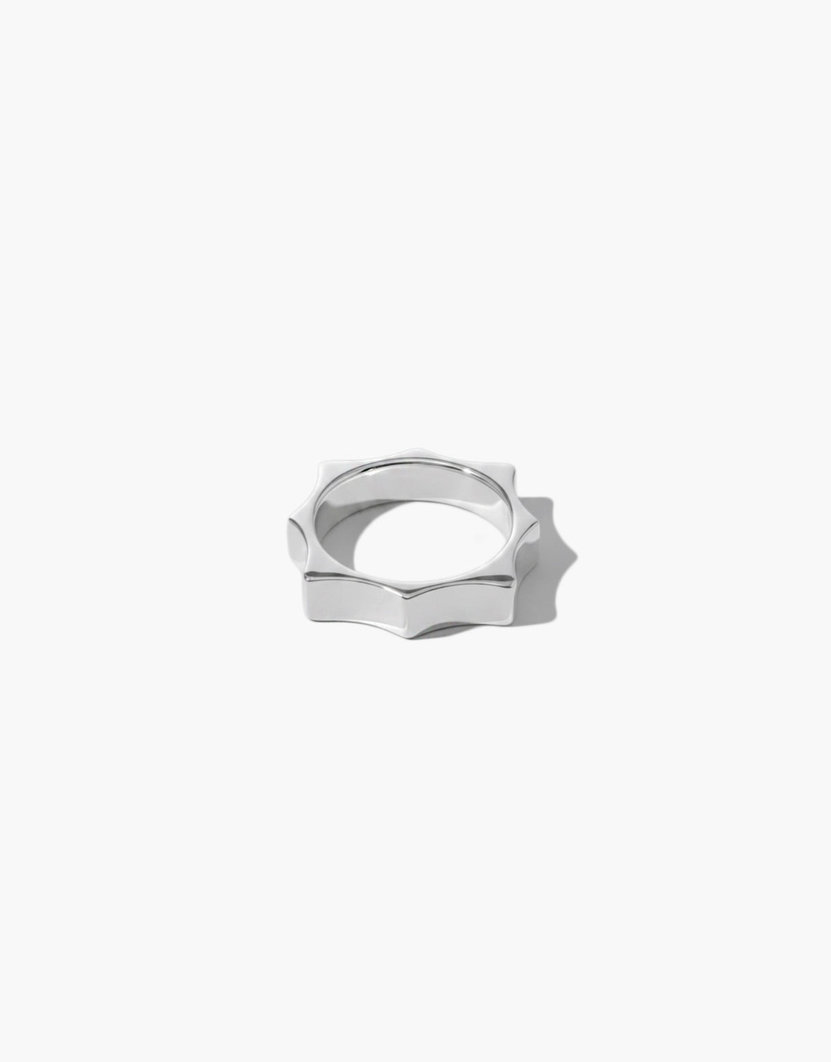 Repeat Ring shown at an angle, the scalloped silhouette catching light along the sterling silver band. Repeat Ring by CLED.