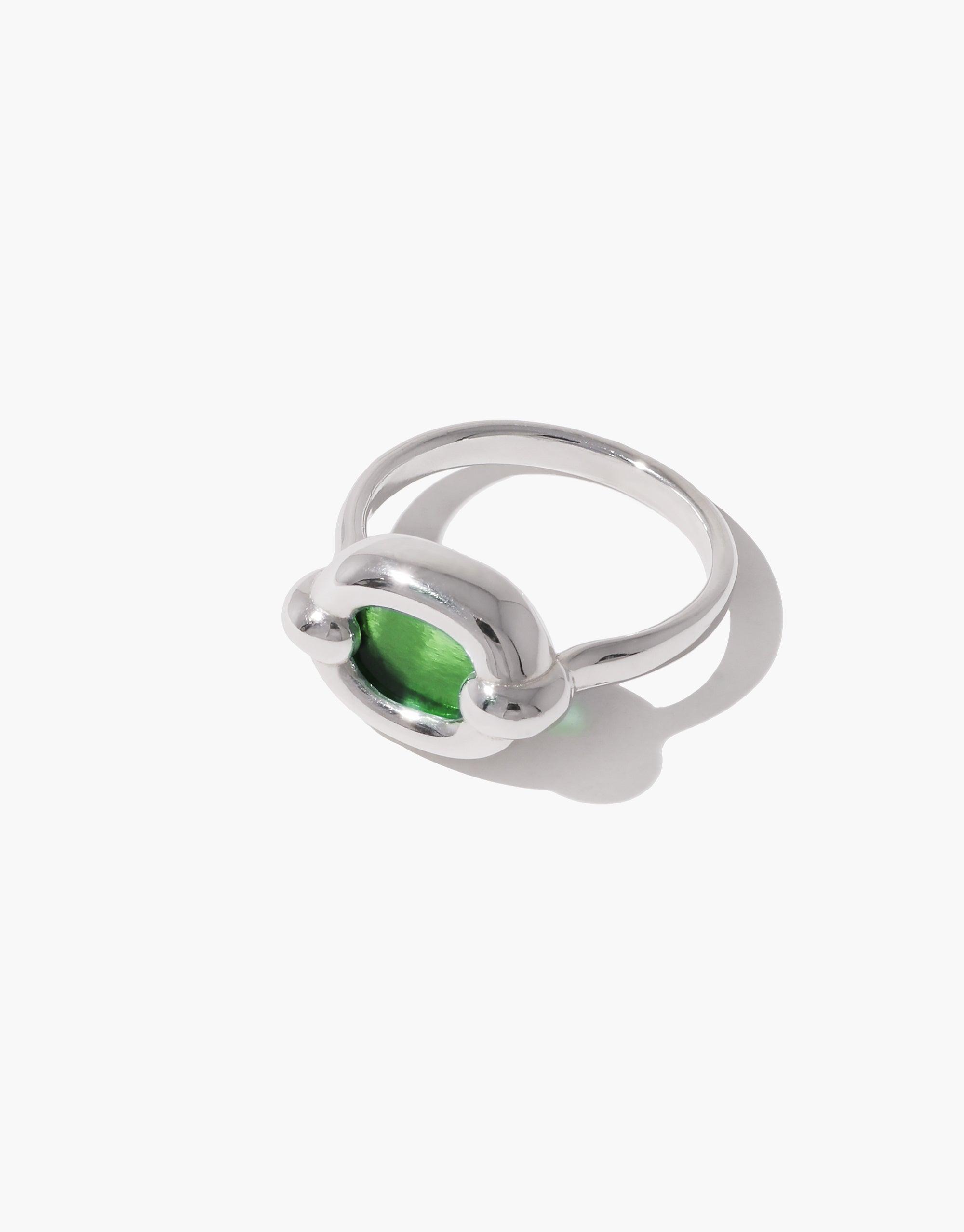 Elegant silver ring with a small green stone encased in a circular setting, showcasing a minimalist design. Part of the In The Loop collection, emphasizing unity and upcycling. Core Loop Ring | Small by CLED
