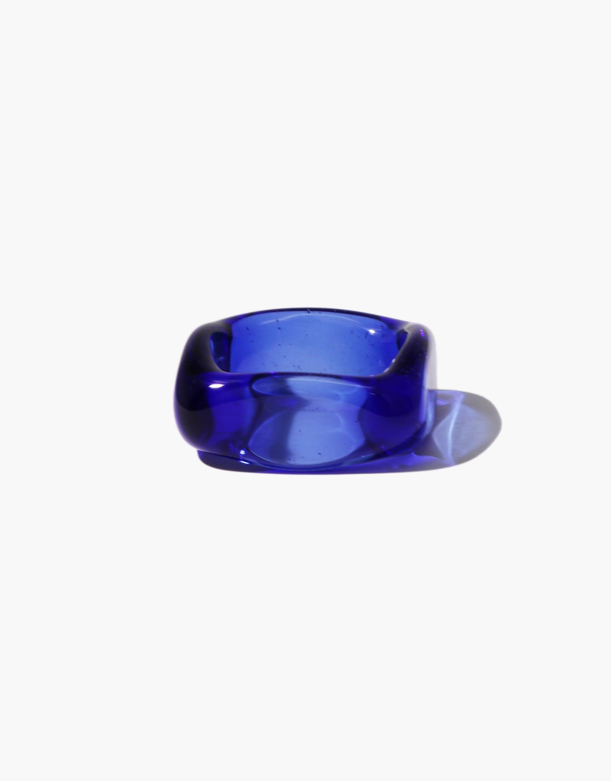 Vibrant blue glass ring with square-shaped design, featuring smooth edges and translucent appearance. Unique Engravable Dice Ring for personalized styling, perfect for custom engraving on four sides. Handcrafted jewelry piece by CLED.