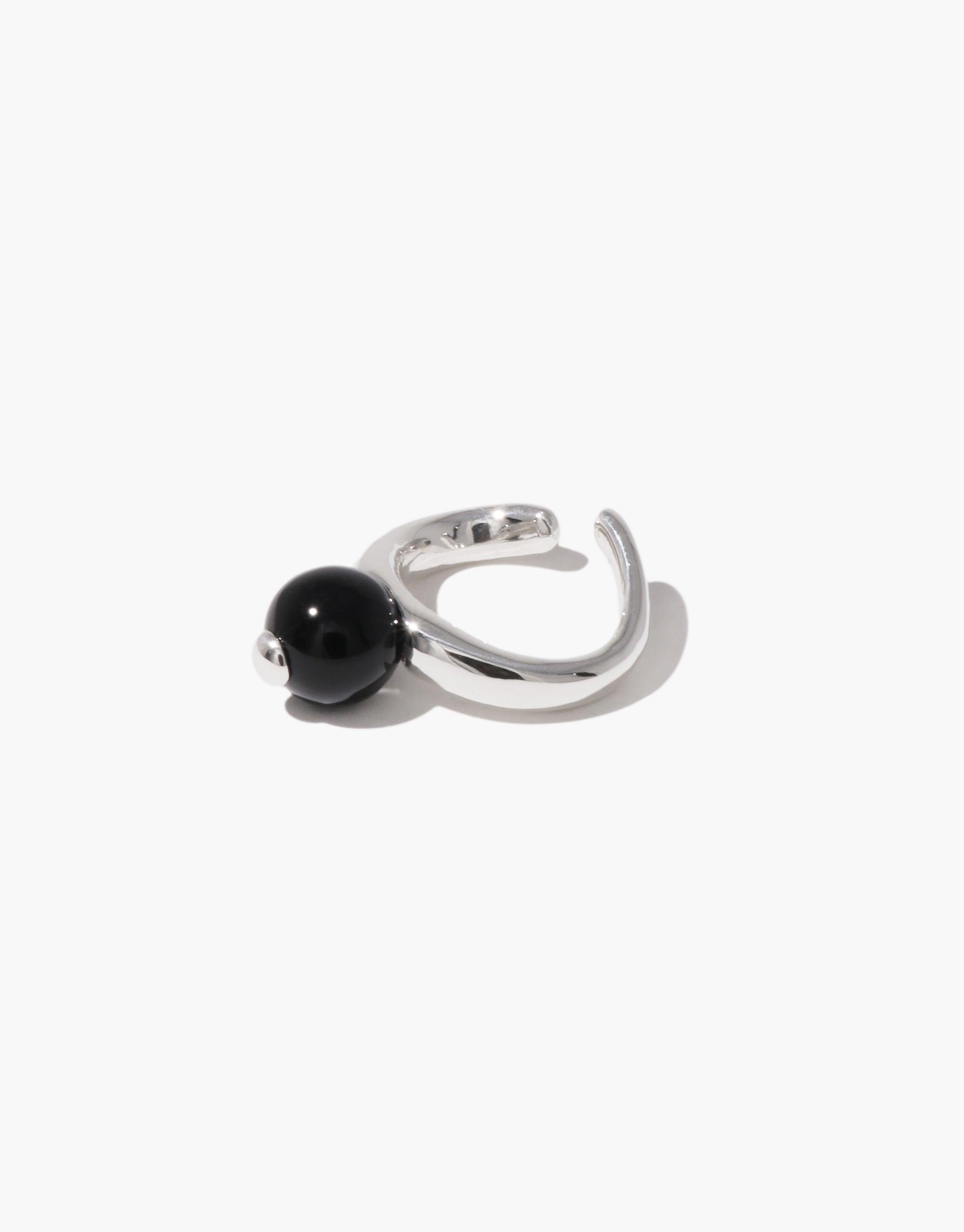 Elegant silver ear cuff featuring a black spherical bead, inspired by the organic shape of a pea pod. Showcases nature-inspired design in a modern, minimalist style. Pea Ear Cuff | Large by CLED