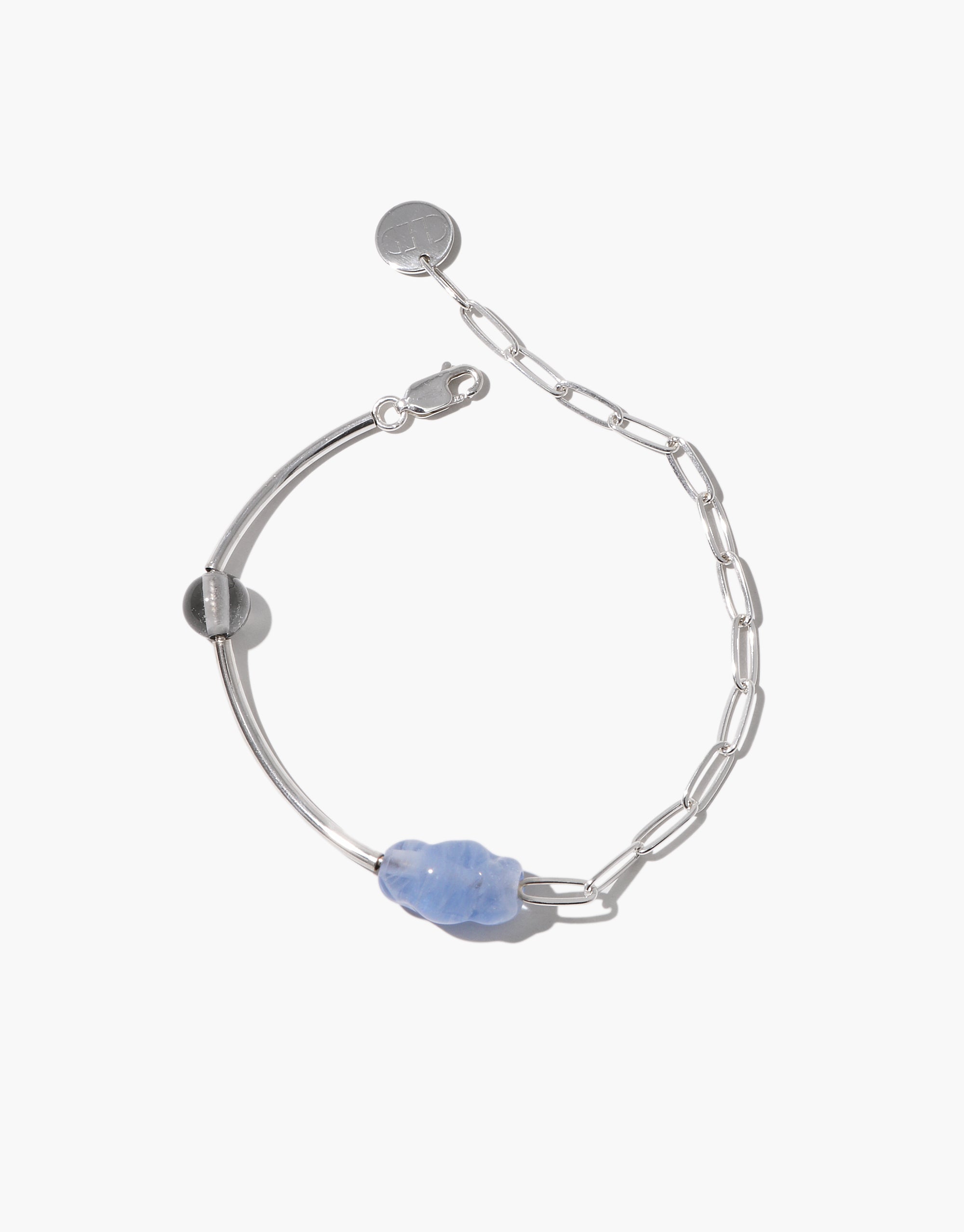 Silver bracelet with a soft blue Eco Gem and a silver-toned round bead, combining elongated chain links and sleek curved bars.