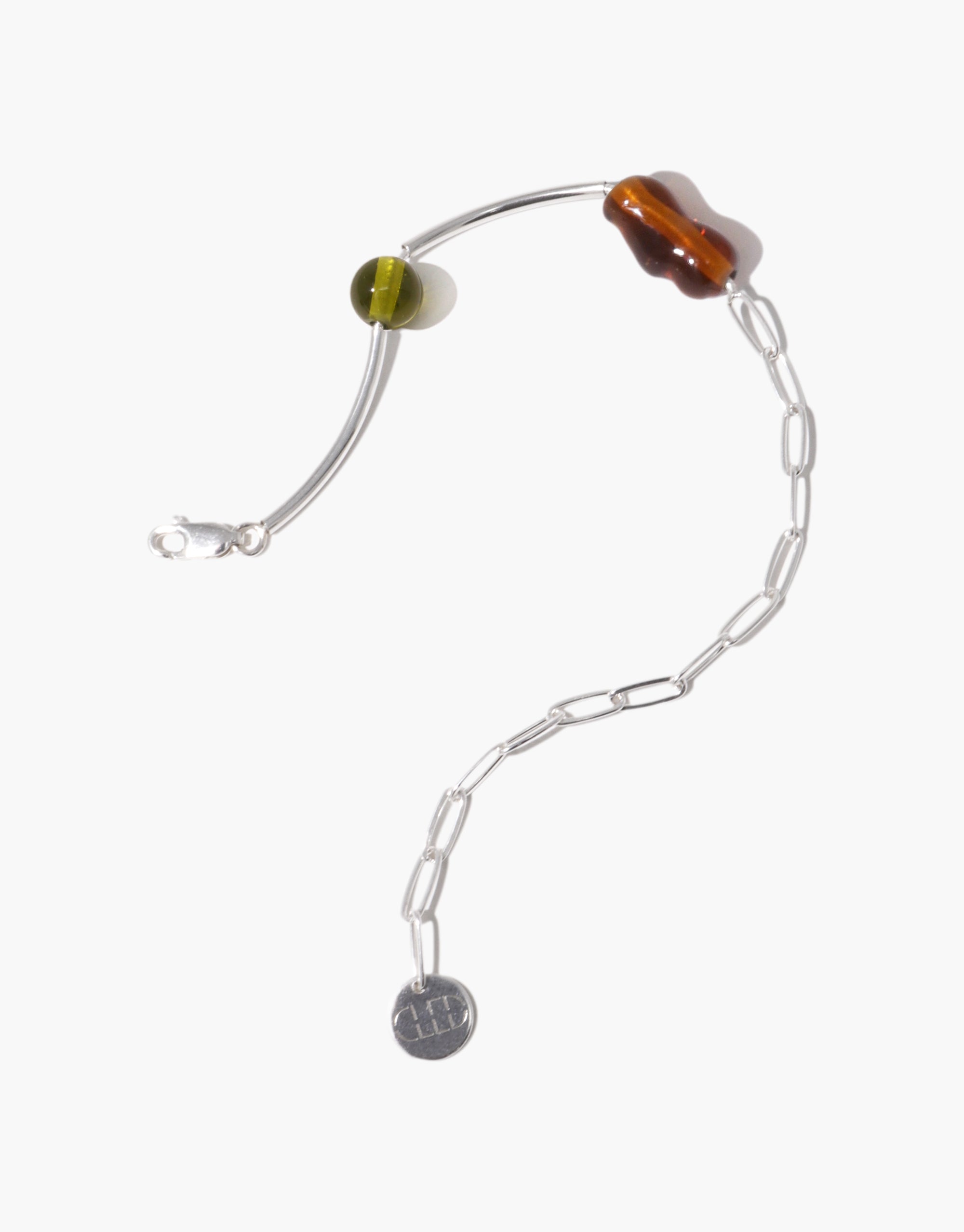Silver bracelet adorned with a warm brown wavy Eco Gem and a translucent olive-green round bead, connected by a fine silver chain and curved bar accents.