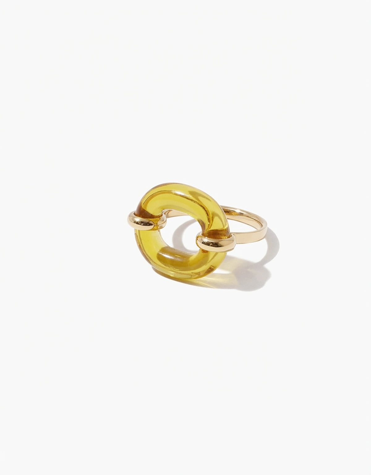 Gold ring with a yellow honeycomb loop design on a white background