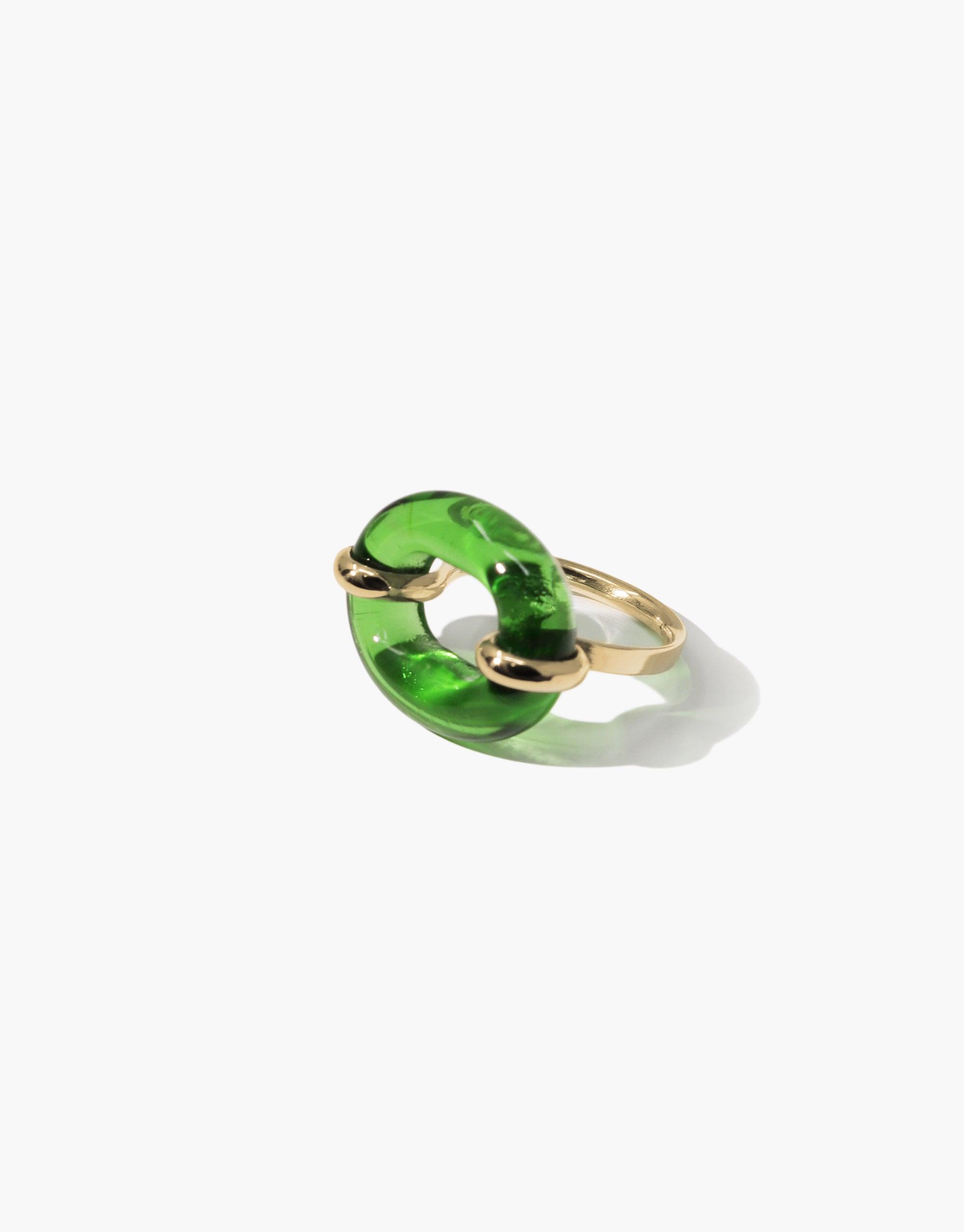 Unique green glass loop ring with gold-toned metal setting, symbolizing connection and sustainability. Elegant and modern design for the In The Loop Ring by CLED