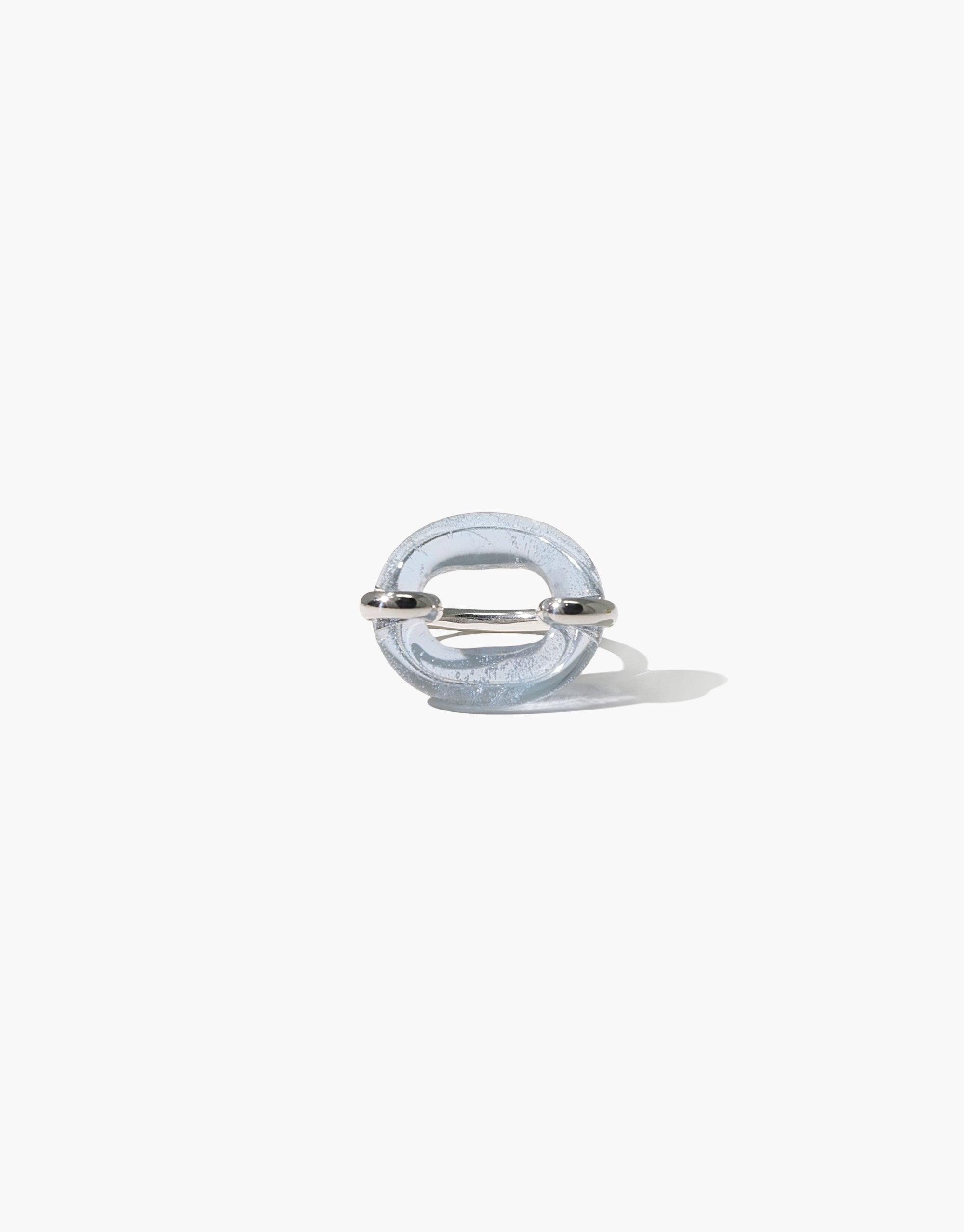 Unique transparent ring with circular design featuring silver accents, symbolizing connection and solidarity. Sustainable jewelry piece "In The Loop Ring" by CLED.