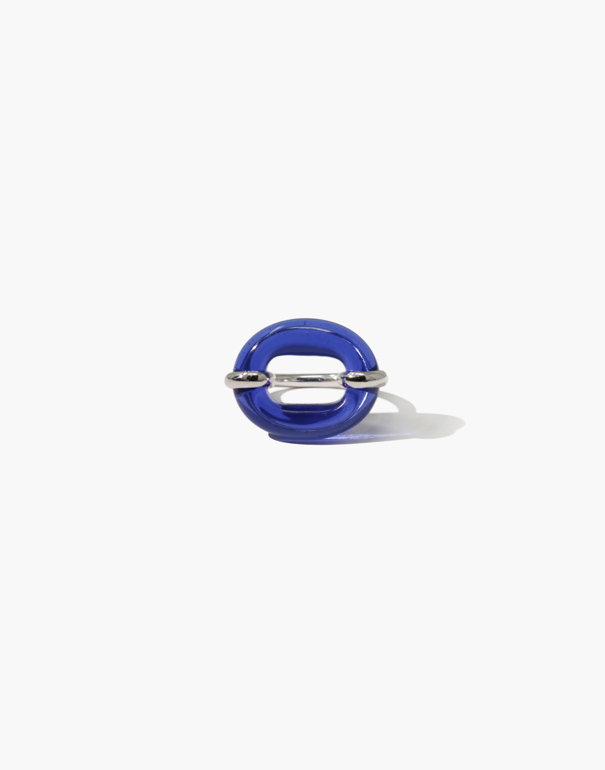 A cobalt blue Eco Gem ring with a sculptural oval loop shape, accented with a sterling silver hardware detail through the center, photographed on a clean white background.