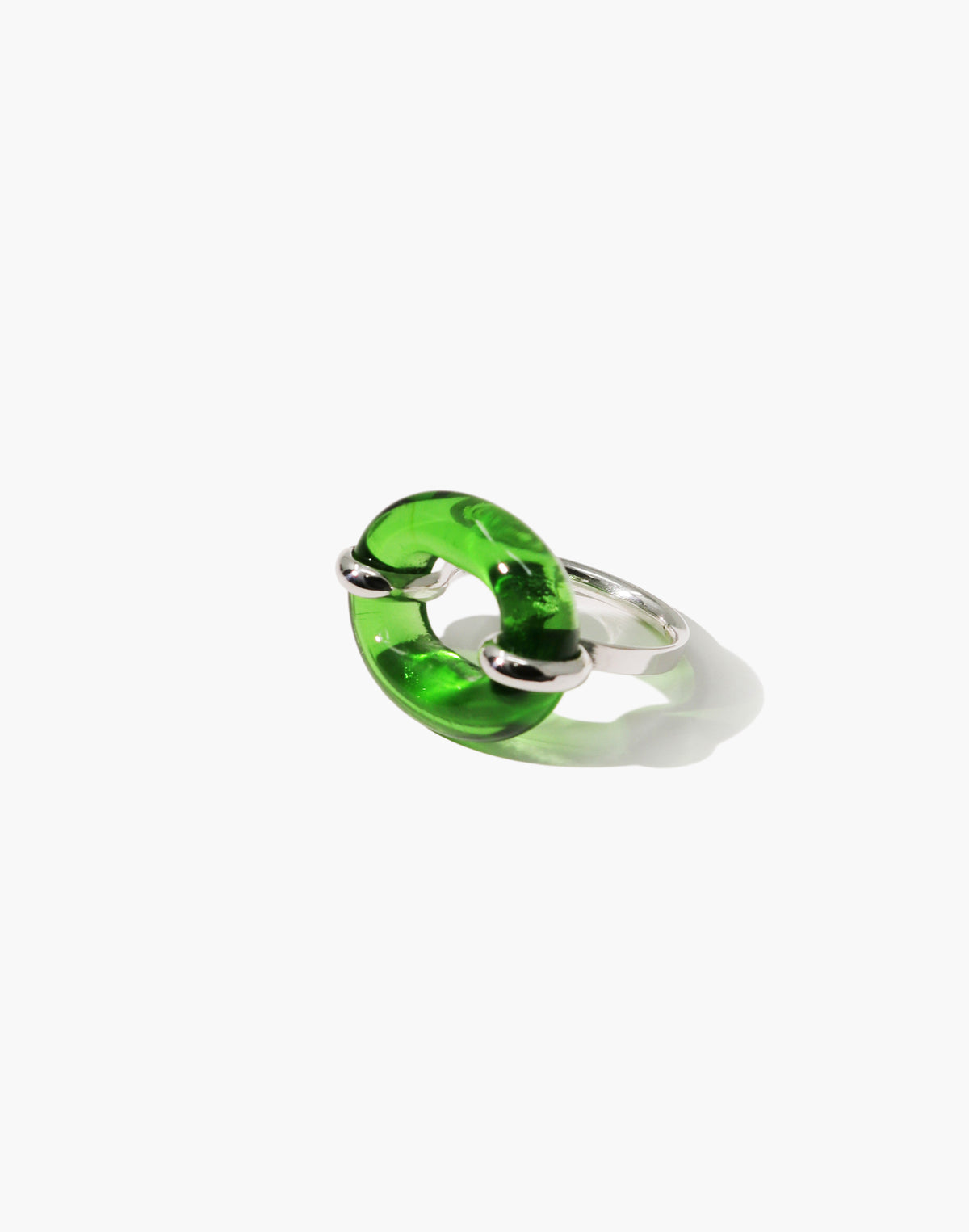 A green Eco Gem ring with a sculptural oval loop shape, accented with a sterling silver hardware detail through the center, photographed on a clean white background.