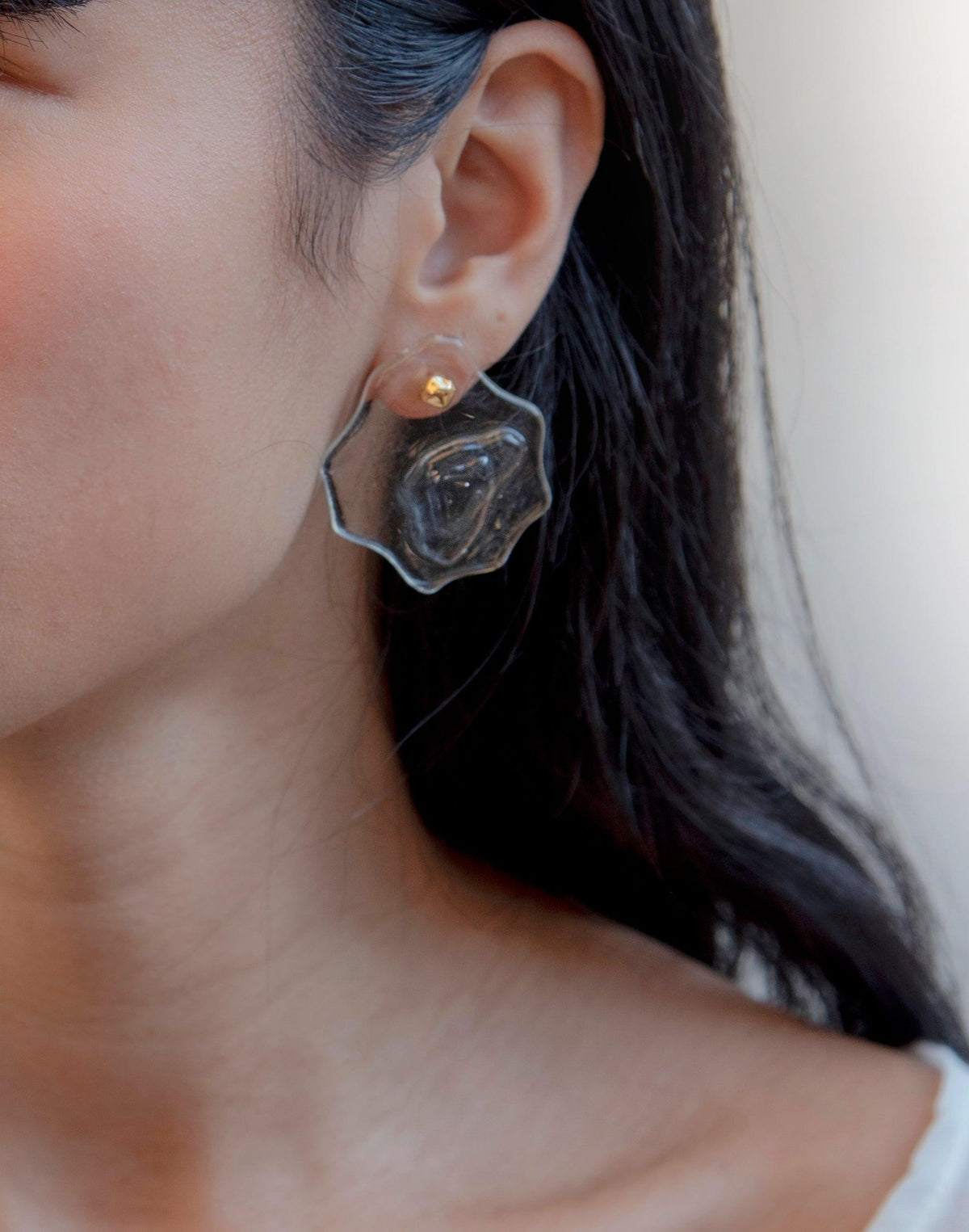 Close-up of Plateau Earrings featuring layered glass design resembling canyon formations, with detachable gold stud. Handcrafted eco-friendly jewelry inspired by terrain, showcasing abstract molten forms and unique texture. Sustainable luxury accessory from the Terrain Collection by CLED.