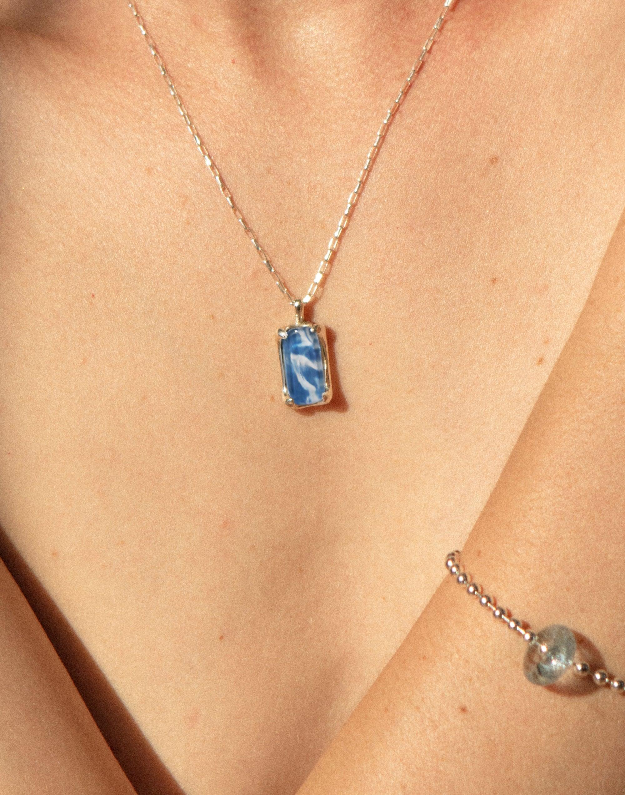 Elegant Prism Necklace with blue marbled pendant on delicate silver chain, showcasing upcycled glass bottle art. Sustainable jewelry piece from the Marble collection, perfect for eco-conscious style. Handcrafted design by CLED. Prism Necklace | Marble.