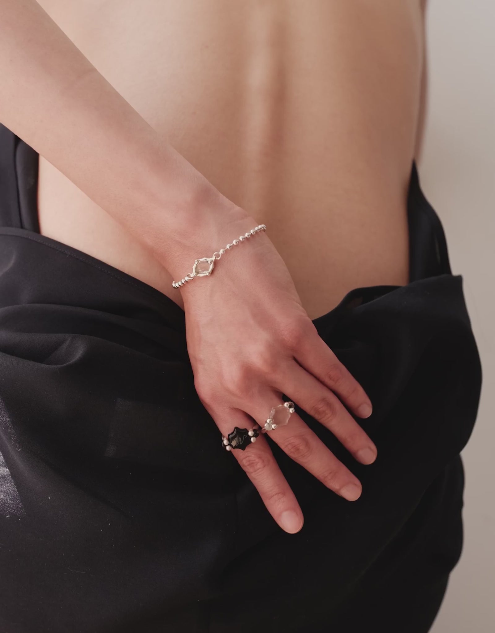 Interlace Bracelet in motion, worn on the model. Upcycled glass Eco Gems in sterling silver, handmade in Los Angeles. Interlace Bracelet by CLED.
