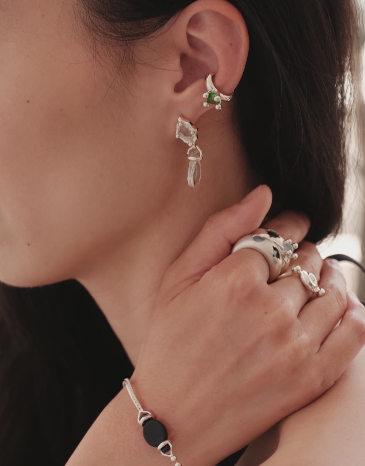 Picot Ear Cuff in motion, worn on the model. Upcycled glass Eco Gems in sterling silver, handmade in Los Angeles. Picot Ear Cuff by CLED.