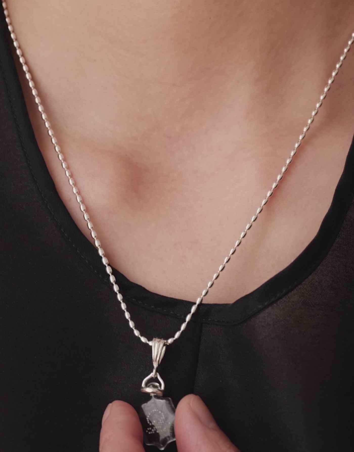 LAS Scallop Pendant in motion, worn on the model. Upcycled glass Eco Gems in sterling silver, handmade in Los Angeles. LAS Scallop Pendant by CLED.